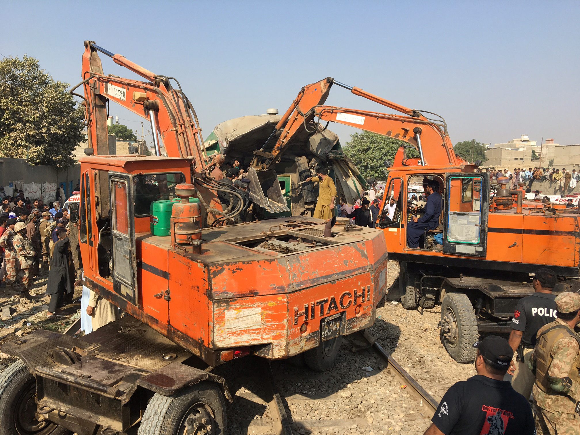 Rescuers workers use heavy machinery on the car of a train which crashed outside Karachi, Pakistan November 3, 2016. REUTERS/Akhtar Soomro