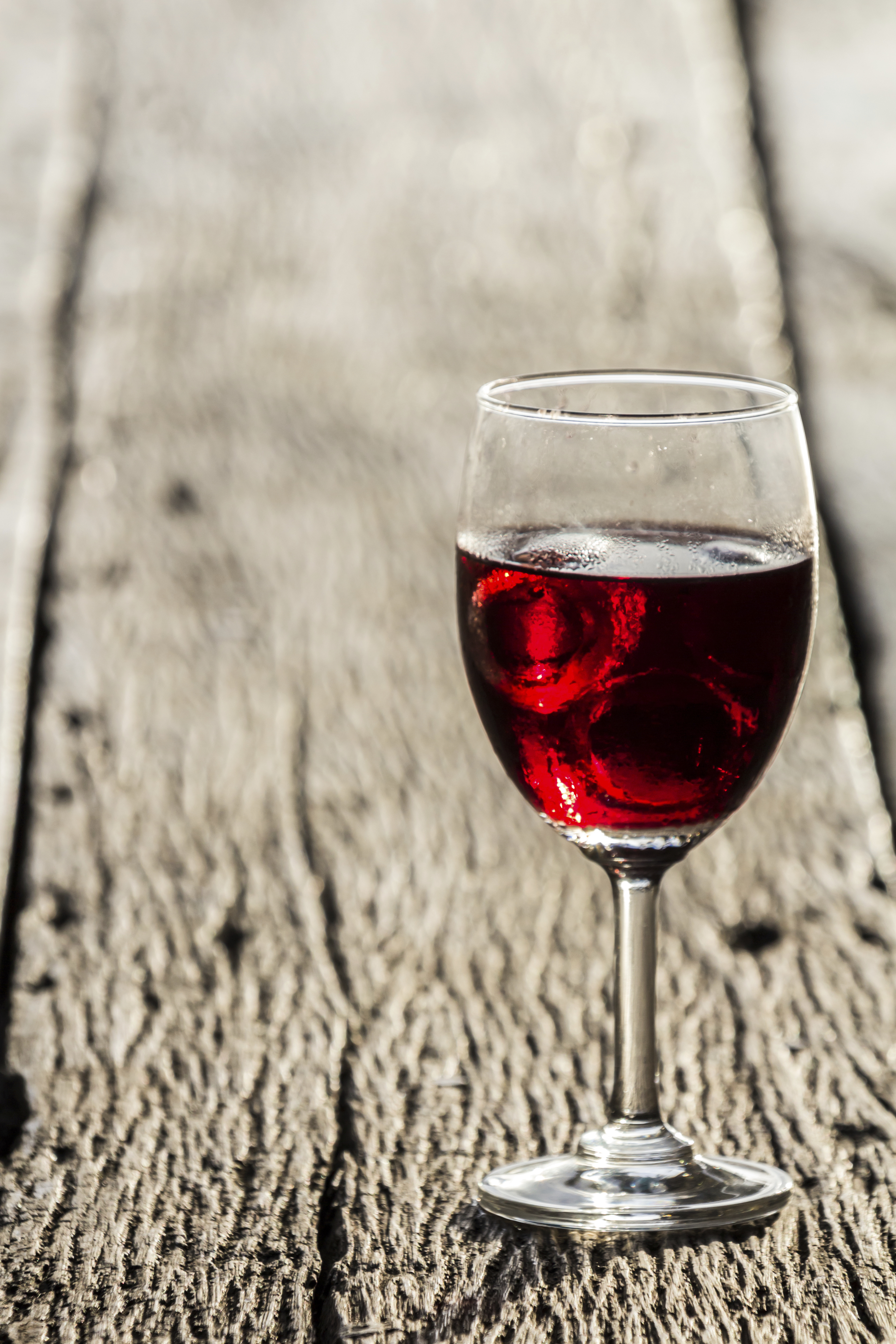 Wine glass on the wooden floor of their home country.