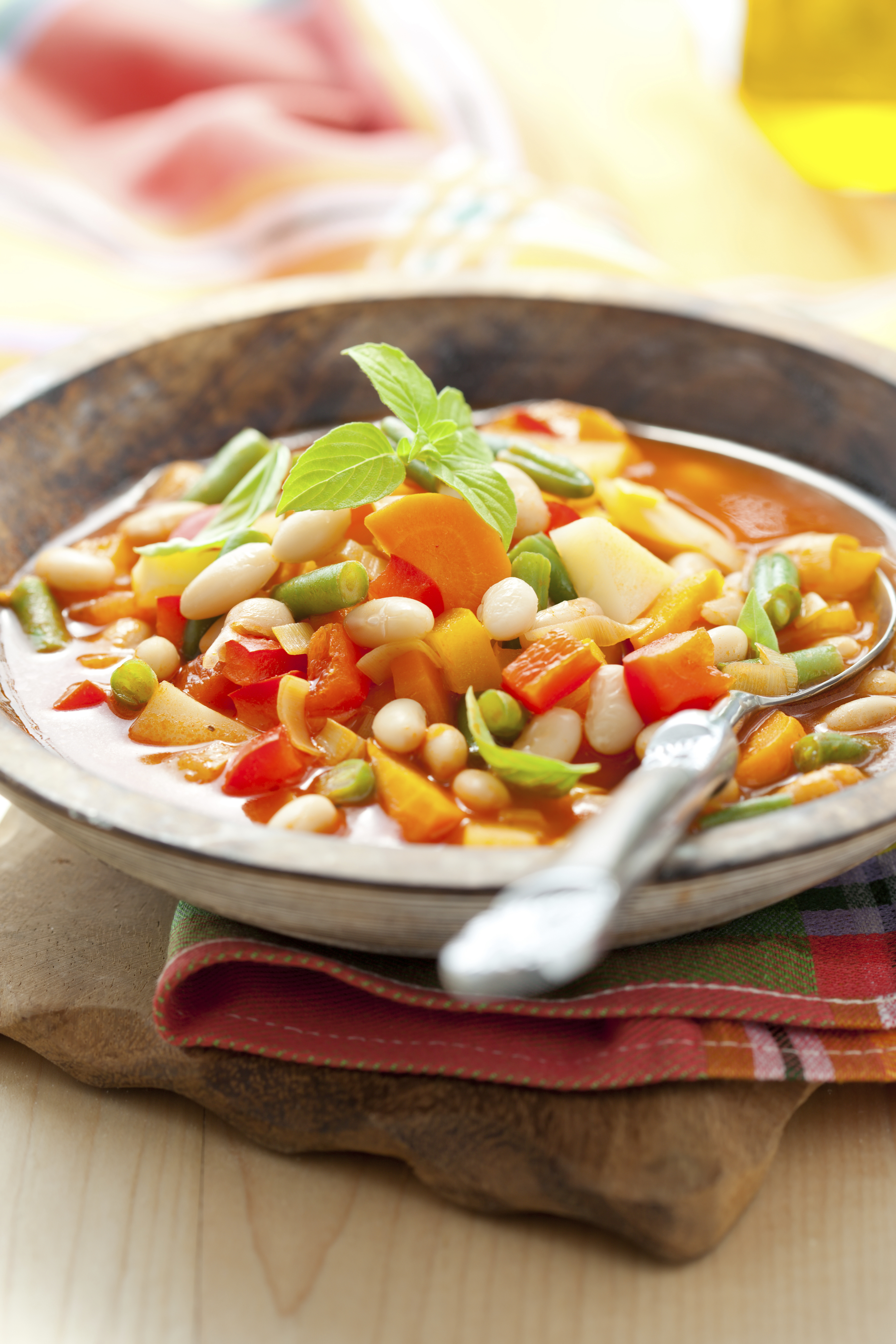 Bowl of minestrone soup in a wooden bowl
