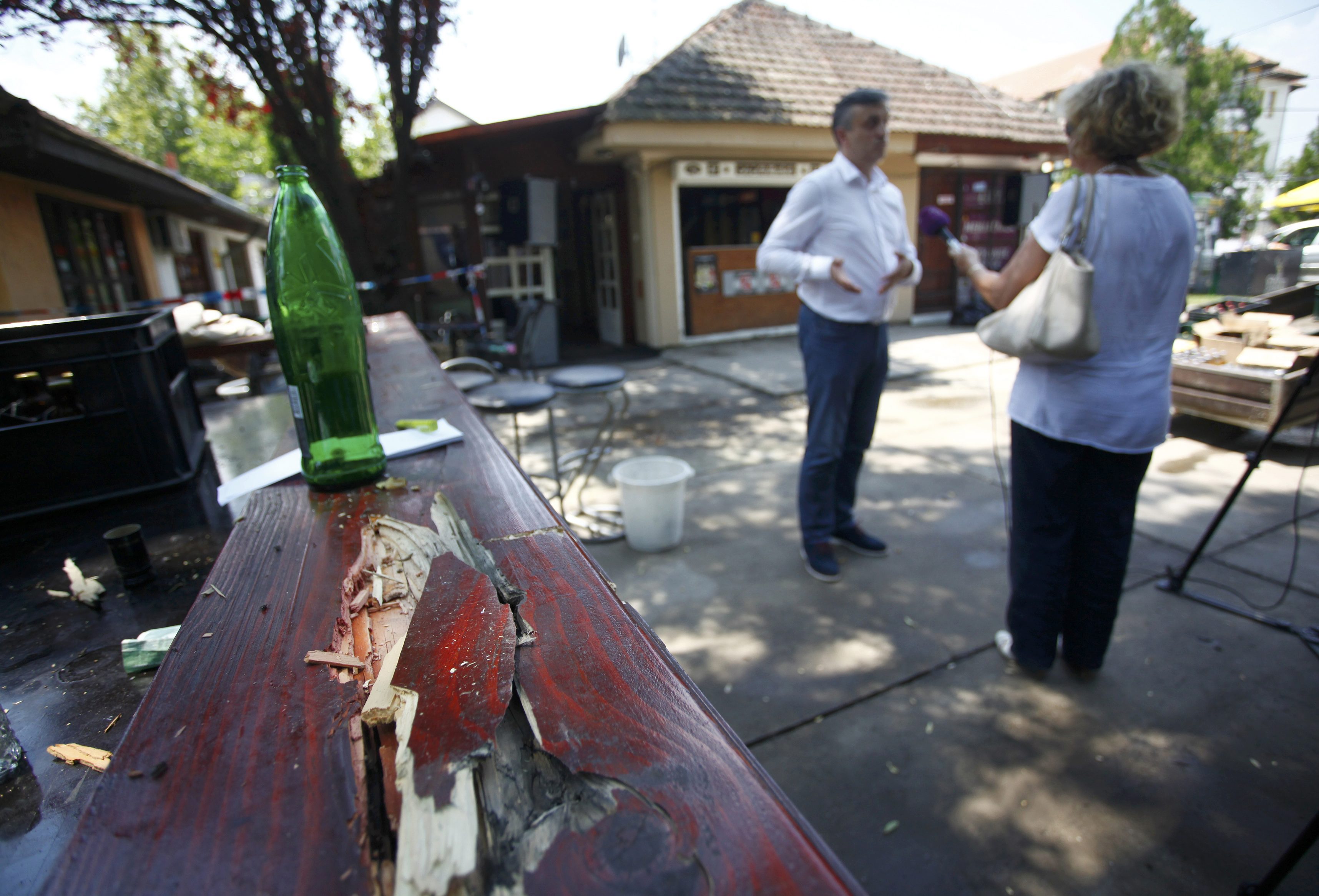A man is interviewed in a cafe after a shooting during a local festival in the village of Zitiste, north of Belgrade, Serbia July 2, 2016.   REUTERS/Djordje Kojadinovic