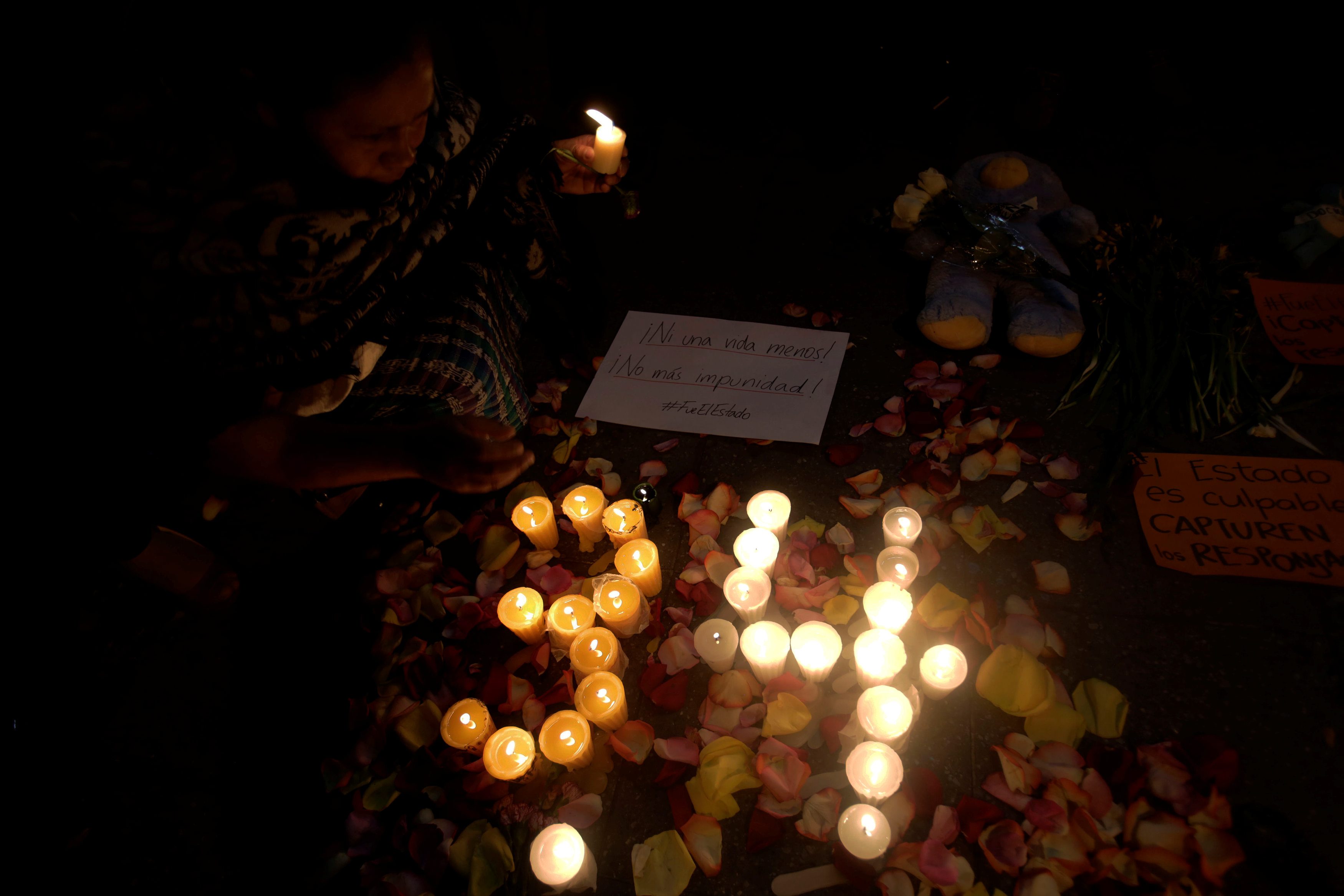 People light candles during a vigil for victims of a fire at the Virgen de Asuncion home in San Jose Pinula, outside National Palace in Guatemala City, March 9, 2017. REUTERS/Saul Martinez