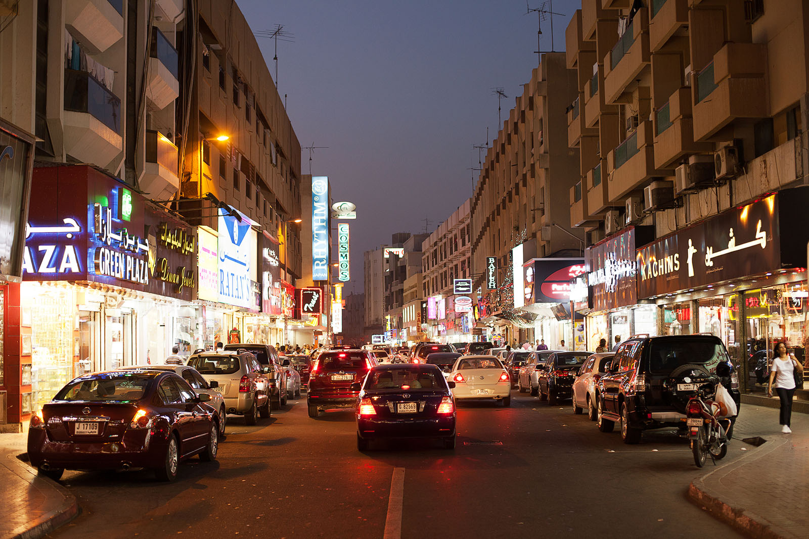 Dubai, United Arab Emirates, June 8, 2013: Night time on the streets of Dubai with brightly lit shops and restaurantsDubai, United Arab Emirates, June 8, 2013: Night time on the streets of Dubai with brightly lit shops and restaurants