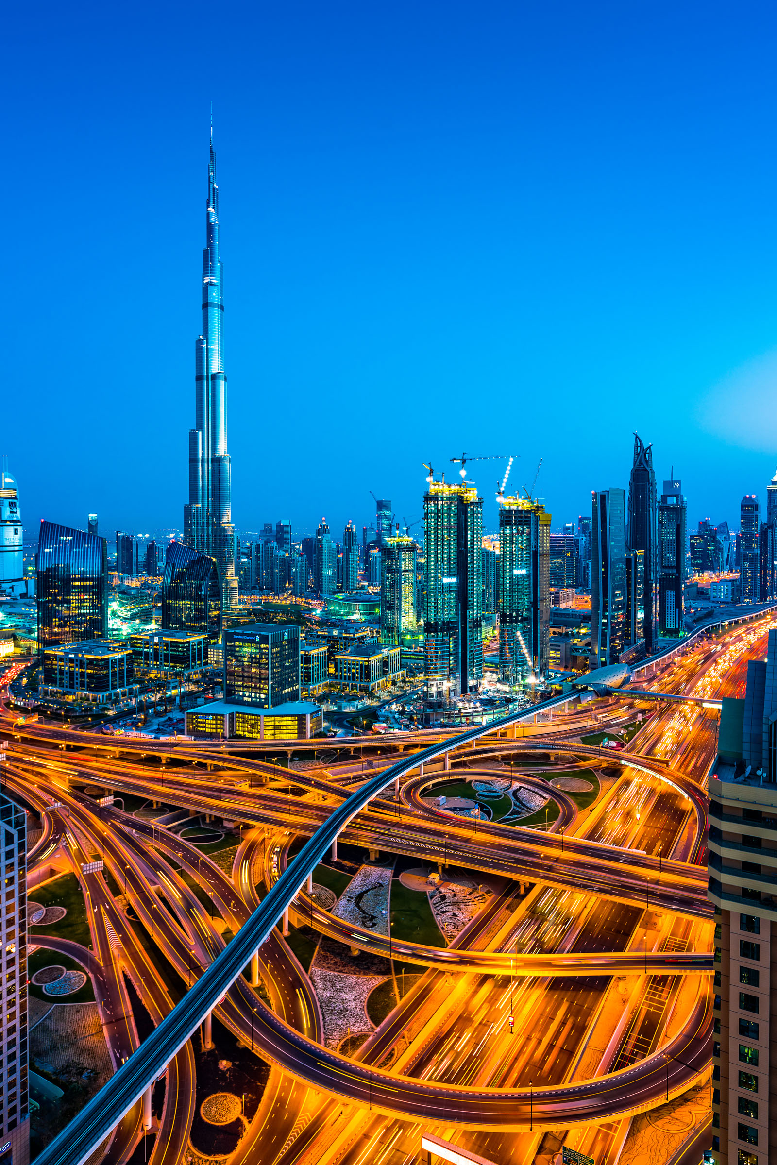 Modern skyscrapers with world's tallest building Burj Khalifa (2016/6) in Downtown Dubai, United Arab Emirates. Dubai is fastest growing city of the world. Large number of tall skyscrapers are built along E11 Sheikh Zayed Road highway with metro line and around futuristic traffic junction.