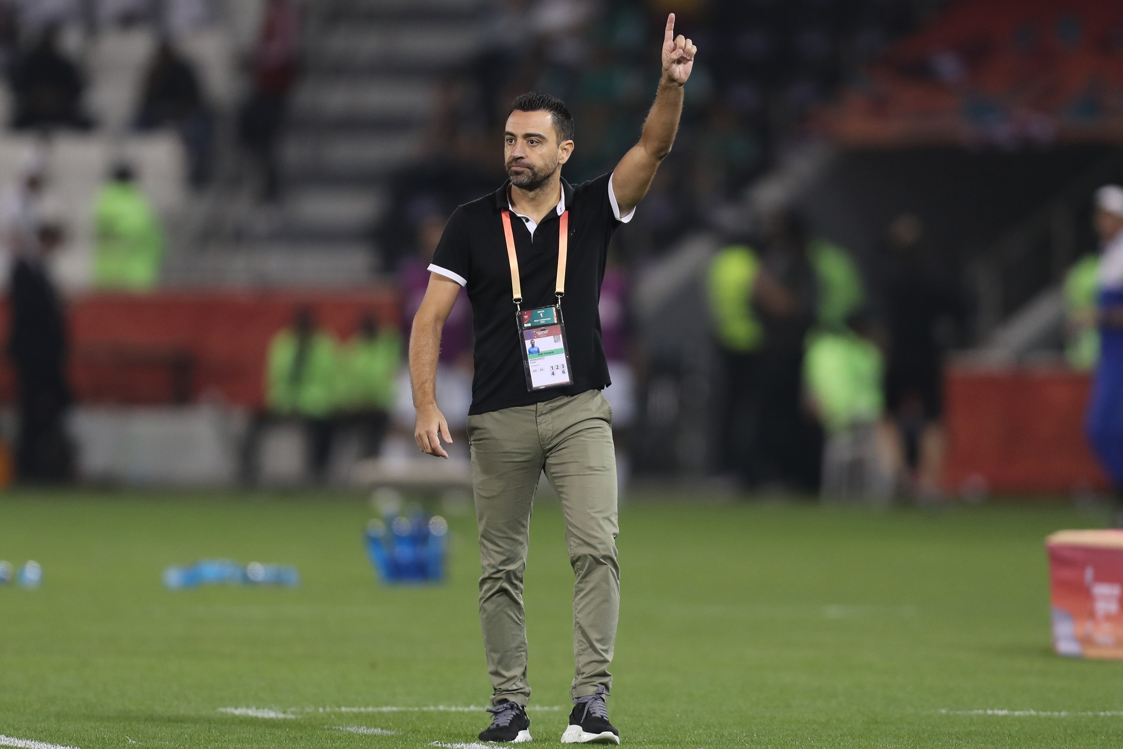 Sadd's coach Xavi speaks to his players during the 2019 FIFA Club World Cup football match between Qatar's Al-Sadd and New Caledonia's Hienghene Sport at the Jassim Bin Hamad Stadium in the Qatari capital Doha on December 11, 2019. (Photo by KARIM JAAFAR / AFP)