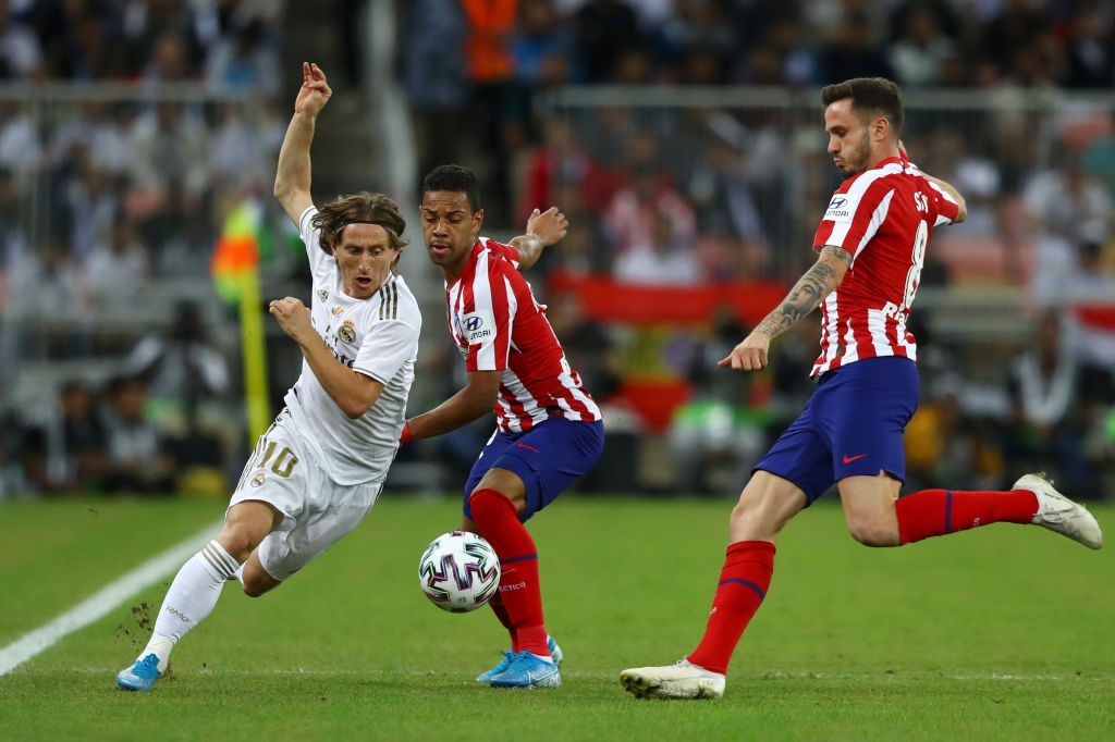JEDDAH, SAUDI ARABIA - JANUARY 12: Luka Modric of Real Madrid battles for possession with Renan Lodi of Atletico Madrid and Saul Niguez of Atletico Madrid  during the Supercopa de Espana Final match between Real Madrid and Club Atletico de Madrid at King Abdullah Sports City on January 12, 2020 in Jeddah, Saudi Arabia. (Photo by Francois Nel/Getty Images)