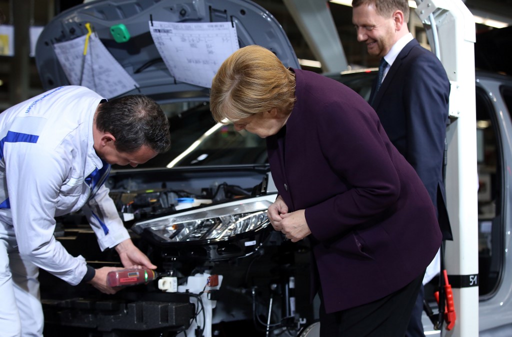 German Chancellor Angela Merkel talks with an employee as she visits Volkswagen's car factory in Zwickau, eastern Germany, on November 4, 2019 on the occasion of the start of the production of the new Volkswagen electric car, the ID.3 model. -  (Photo by RONNY HARTMANN / AFP)