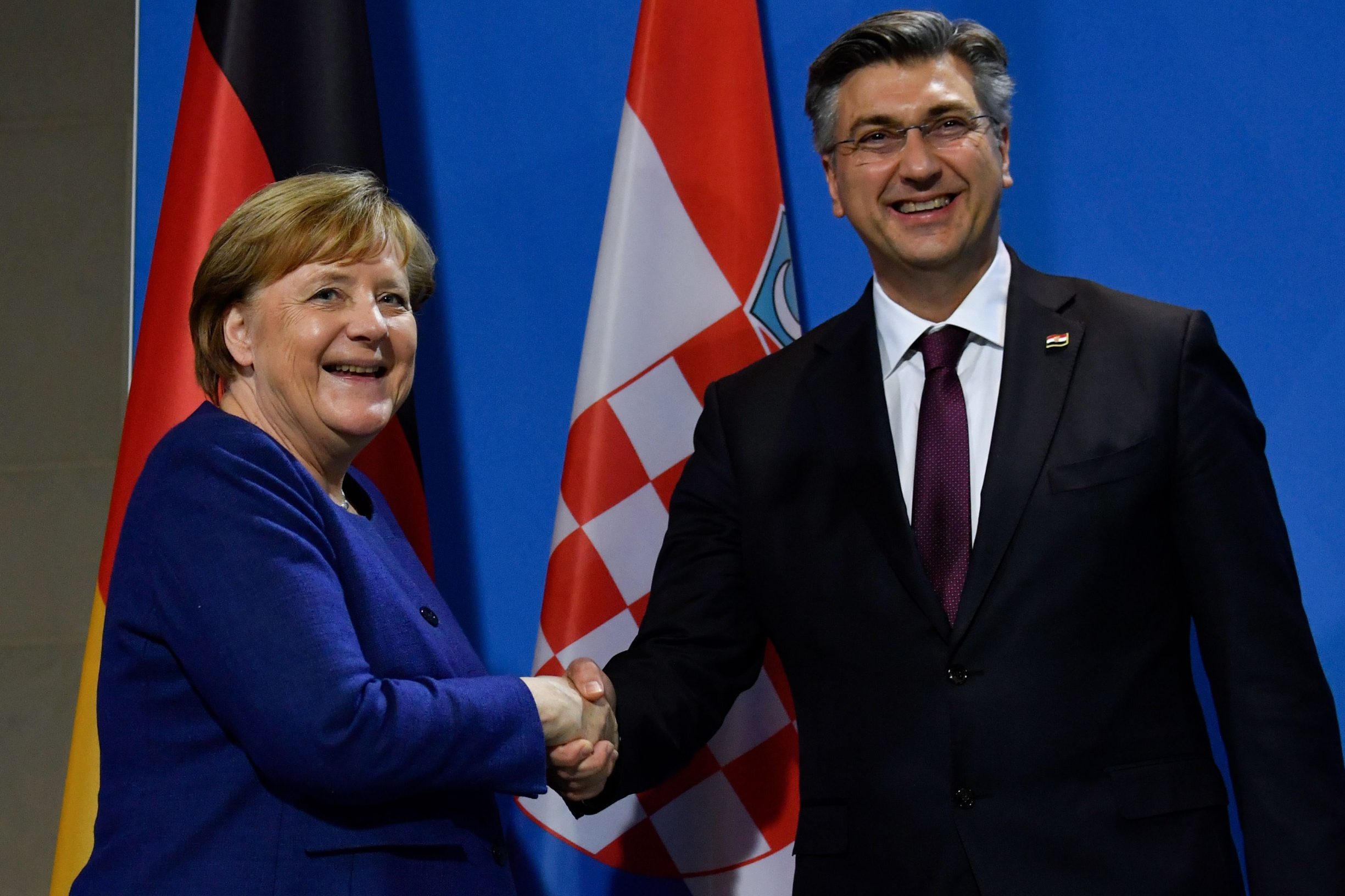 German Chancellor Angela Merkel (L) and Croatian Prime Minister Andrej Plenkovic shake hands after a press conference at the Chancellery on January 16, 2020 in Berlin. (Photo by John MACDOUGALL / AFP)