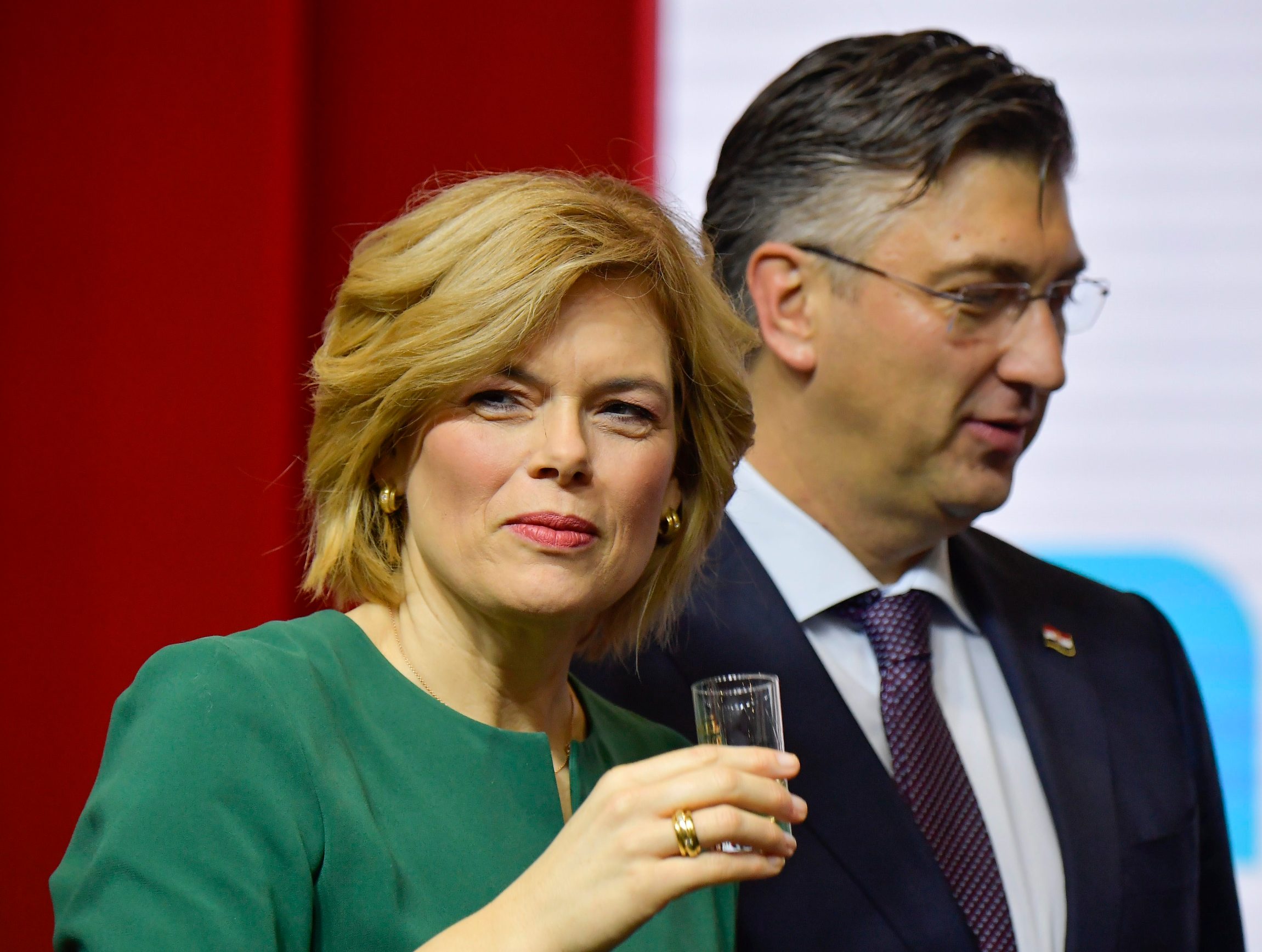 German Minister for Food and Agriculture Julia Kloeckner tastes a drink as she and Croatia's Prime Minister Andrej Plenkovic open the Gruene Woche (Green Week) international agriculture fair in Berlin on January 17, 2020. - The fair officially opens on January 17, 2020 and runs until January 26, with Croatia as partner country of the Green Week 2020. (Photo by Tobias SCHWARZ / AFP)