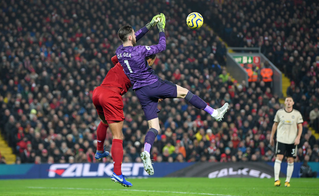 LIVERPOOL, ENGLAND - JANUARY 19: David De Gea of Manchester United attempts to collect the ball as he is challenged by Virgil van Dijk of Liverpool during the Premier League match between Liverpool FC and Manchester United at Anfield on January 19, 2020 in Liverpool, United Kingdom. (Photo by Michael Regan/Getty Images)