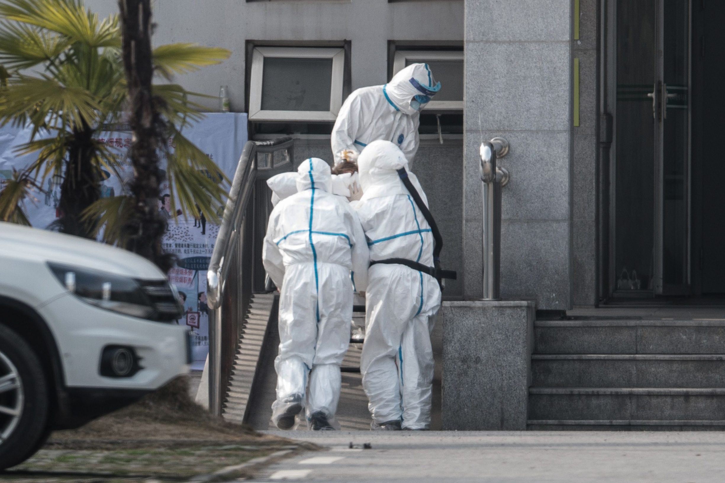 Medical staff members carry a patient into the Jinyintan hospital, where patients infected by a mysterious SARS-like virus are being treated, in Wuhan in China's central Hubei province on January 18, 2020. - The true scale of the outbreak of a mysterious SARS-like virus in China is likely far bigger than officially reported, scientists have warned, as countries ramp up measures to prevent the disease from spreading. (Photo by STR / AFP) / China OUT