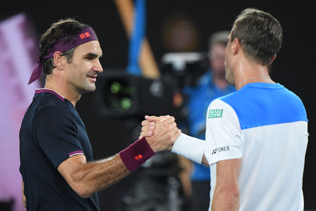 MELBOURNE, AUSTRALIA - JANUARY 20: Roger Federer of Switzerland and Steve Johnson of the United States of America embrace at the net following their Men's Singles first round match on day one of the 2020 Australian Open at Melbourne Park on January 20, 2020 in Melbourne, Australia. (Photo by Quinn Rooney/Getty Images)