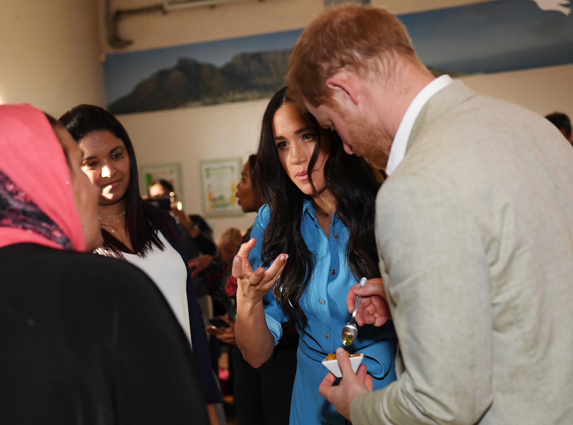 CAPE TOWN, SOUTH AFRICA - SEPTEMBER 23: Meghan, Duchess of Sussex and Prince Harry, Duke of Sussex visit the District 6 Homecoming centre on September 23, 2019 in Cape Town, South Africa. District 6 is a former inner-city residential area in Cape Town, where freed slaves, artisans, immigrants, merchants and the Cape Malay community lived. For over a hundred years, different communities and races lived side by side, and the District became known for its vibrant culture, music and food. In 1966, the government declared District 6 a whites-only area, and over 60,000 residents were forcibly removed and relocated to the Cape Flats Township. (Photo by Facundo Arrizabalaga - Pool/Getty Images)