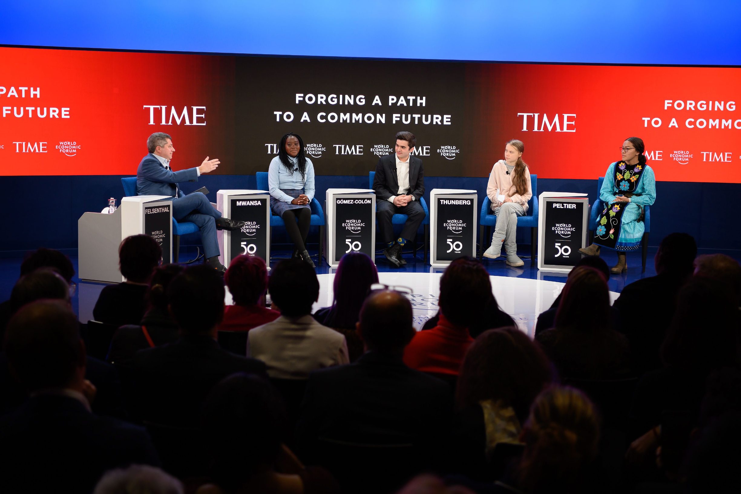 Swedish climate activist Greta Thunberg (2ndR), Canadian climate and environmental activist Autumn Peltier (R), Zambian child and womens rights advocate and activist Natasha Wang Mwansa (2ndL), Puerto Rican founder of Light and Hope for Puerto Rico Salvador Gomez-Colon (C) and US jounalist and Time magazine editor-in-chief Edward Felsenthal (L) attend a session at the Congres center during the World Economic Forum (WEF) annual meeting in Davos, on January 21, 2020. (Photo by Fabrice COFFRINI / AFP)