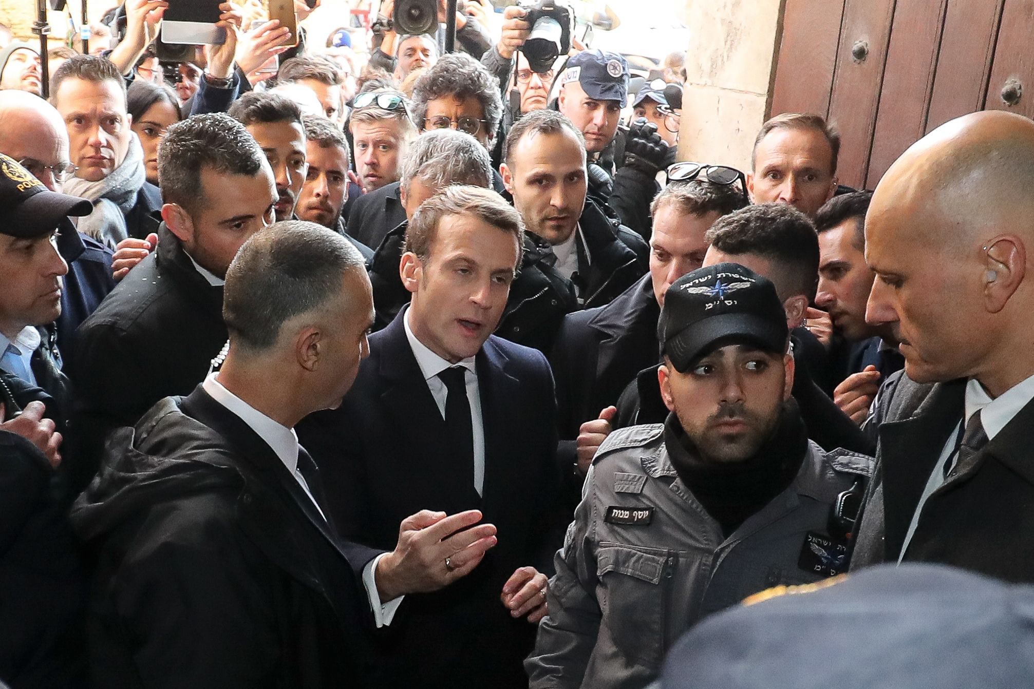 French President Emmanuel Macron asks the Israeli police to leave the 12th-century Church of Saint Anne in the old city of Jerusalem on January 22, 2020. - World leaders are to travel to Israel this week to mark 75 years since the Red Army liberated Auschwitz, the extermination camp where the Nazis killed over a million Jews. Thousands of police officers and other security forces will deploy from today, ahead of the arrival of dignitaries including Russian President Vladimir Putin, French President Emmanuel Macron and US Vice President Mike Pence. (Photo by Ludovic Marin / AFP)