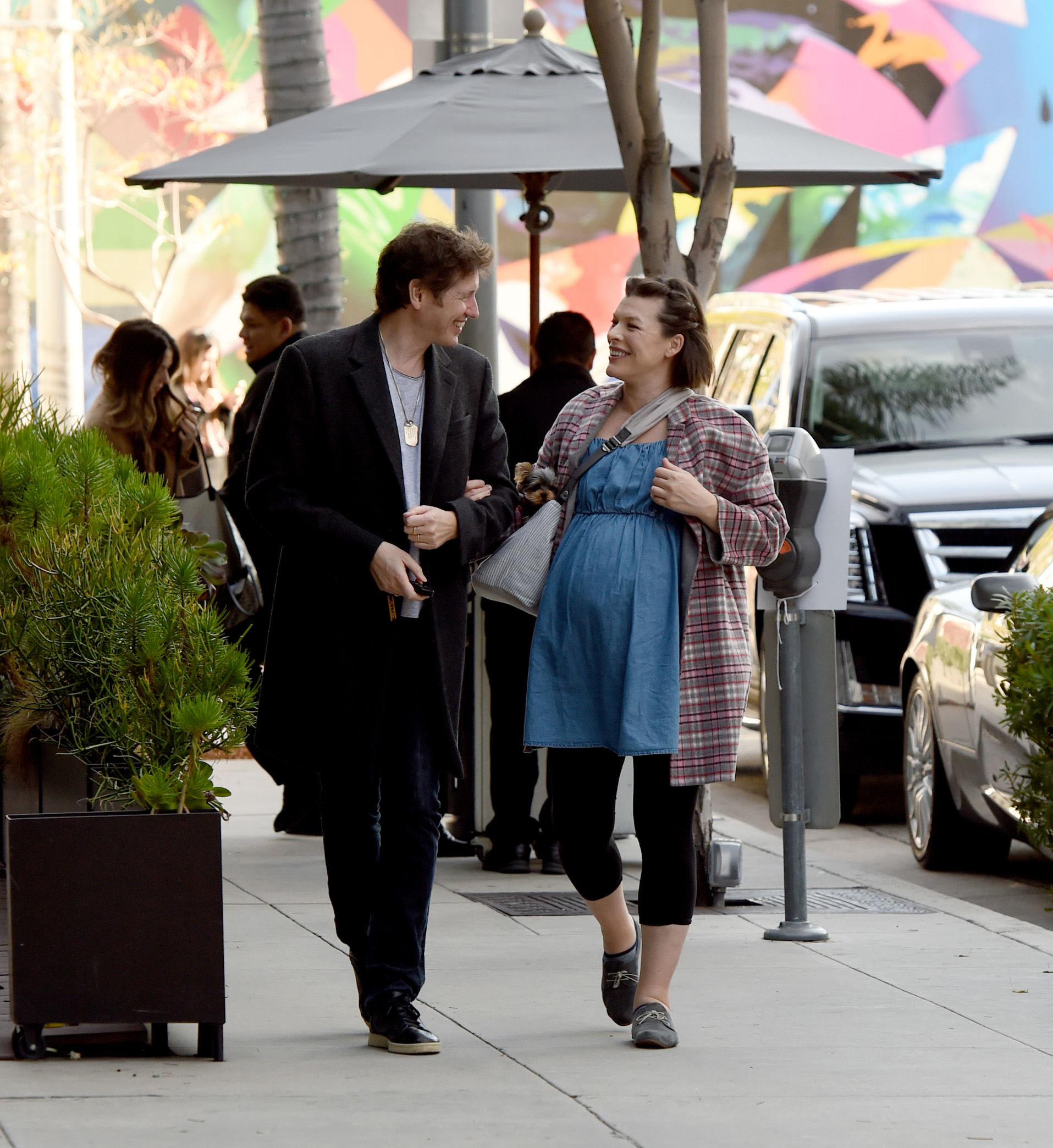 01/21/2020 EXCLUSIVE: Milla Jovovich shows off her burgeoning baby bump as she and husband Paul head to Spago restaurant in Beverly Hills, California. The two were in a very joyous mood as they walked to their car after their meal. Milla is wearing a plaid blazer, black leggings and baby blue loose fitted dress., Image: 494007773, License: Rights-managed, Restrictions: Exclusive NO usage without agreed price and terms. Please contact sales@theimagedirect.com, Model Release: no, Credit line: TheImageDirect.com / The Image Direct / Profimedia