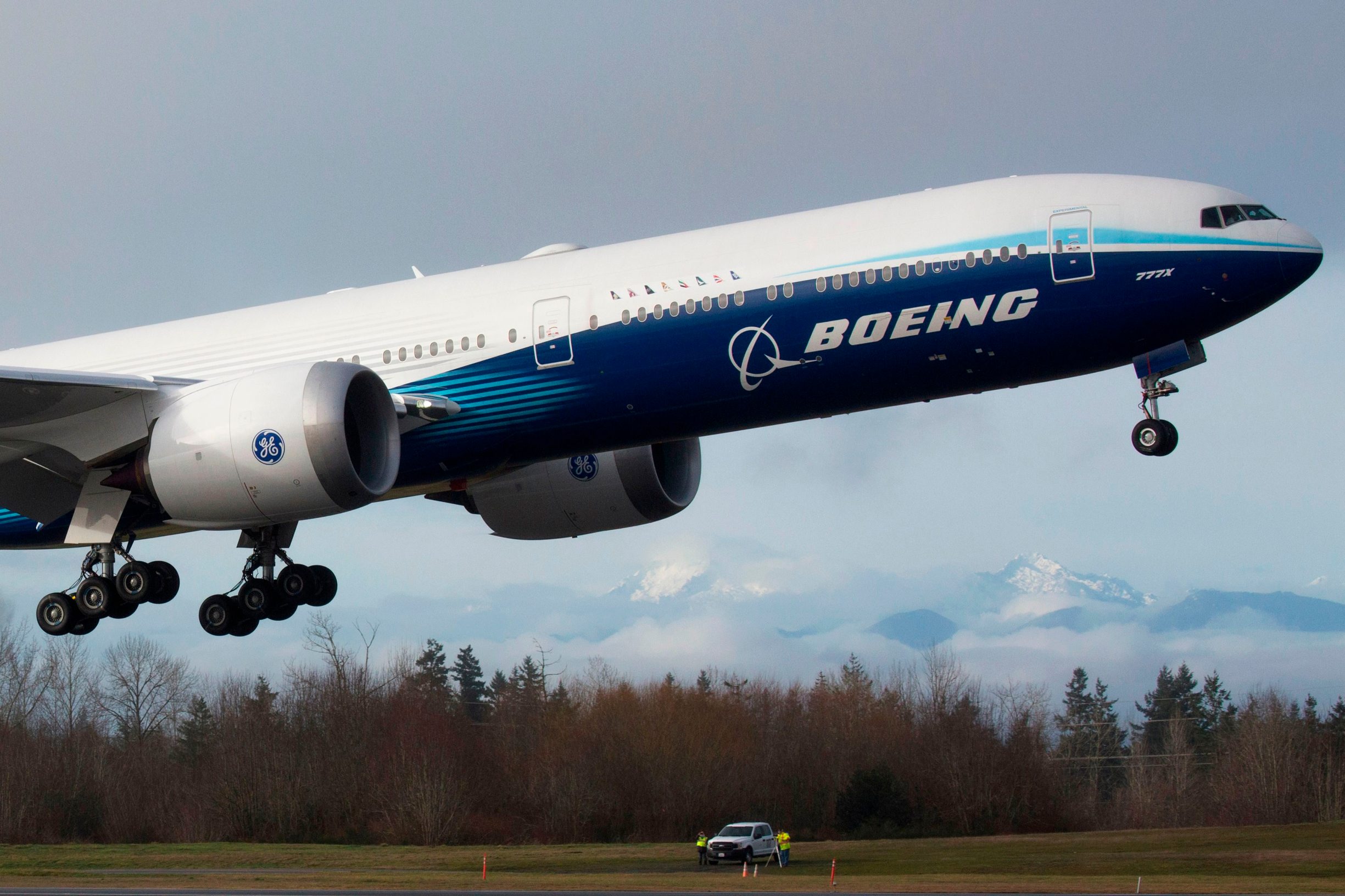 A Boeing 777X airplane takes off on its inaugural flight at Paine Field in Everett, Washington on January 25, 2020. - Boeing's new long-haul 777X airliner made its first flight Saturday, a major step forward for the company whose broader prospects remain clouded by the 737 MAX crisis. The plane took off from a rain-slicked runway a few minutes after 10:00 am local time (1800 GMT), at Paine Field in Everett, Washington, home to Boeing's manufacturing site in the northwestern US. (Photo by Jason Redmond / AFP)