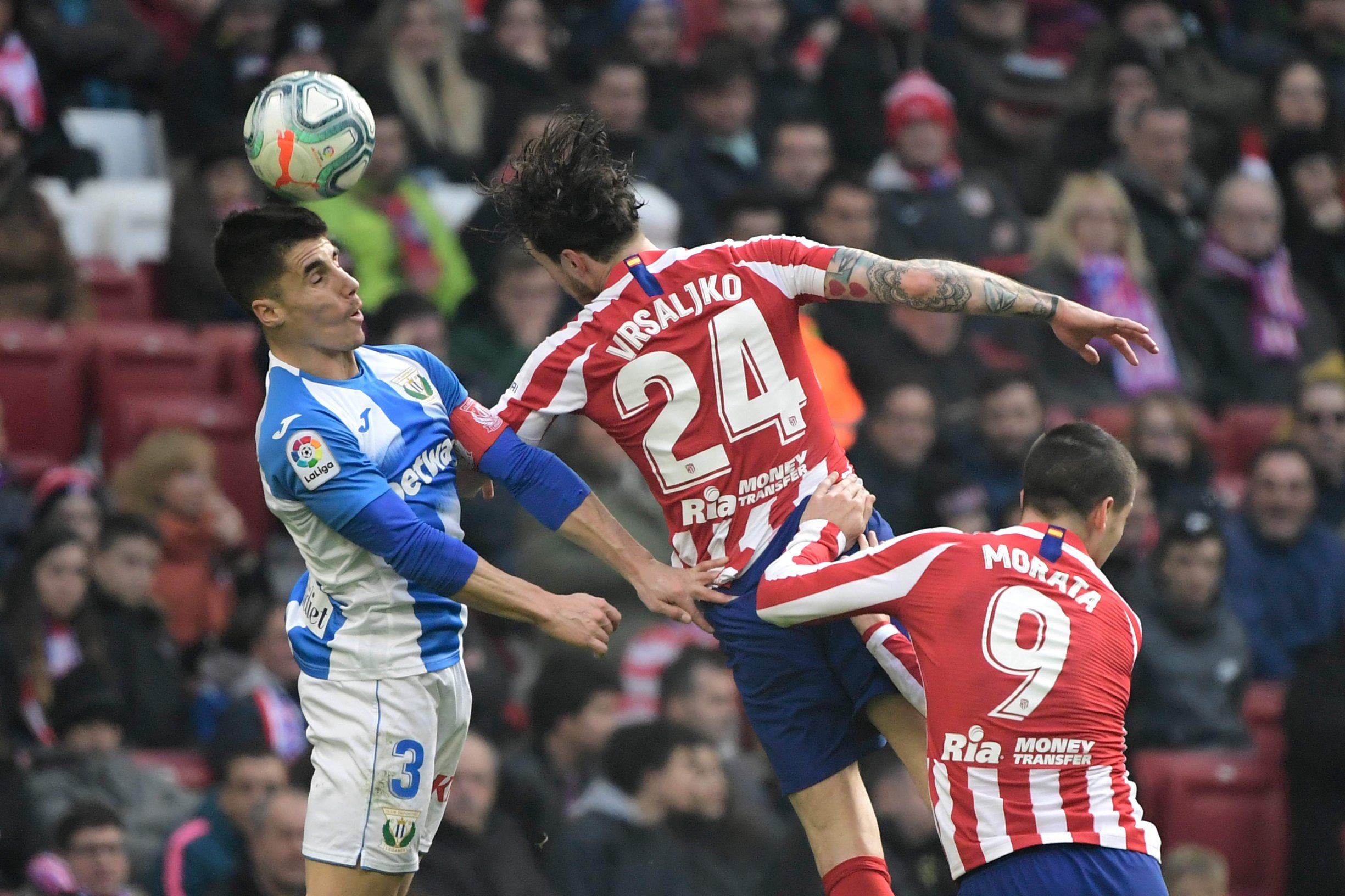 (FromL) Leganes' Spanish defender Unai Bustinza, Atletico Madrid's Croatian defender Sime Vrsaljko and Atletico Madrid's Spanish forward Alvaro Morata jump for the ball during the Spanish league football match Club Atletico de Madrid against Club Deportivo Leganes SAD at the Wanda Metropolitano stadium in Madrid on January 26, 2020. (Photo by JAVIER SORIANO / AFP)