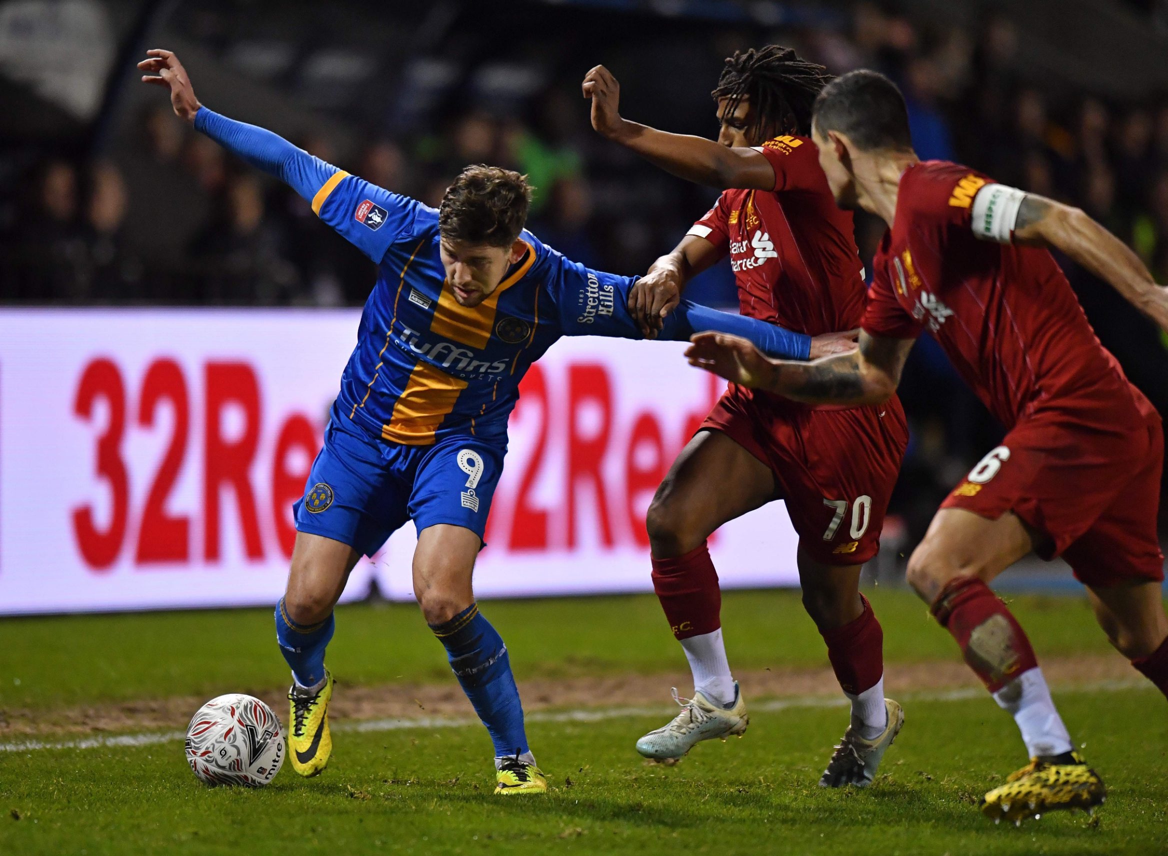 Shrewsbury Town's English striker Callum Lang (L) vies for the ball against Liverpool's Algerian defender Yasser Larouci (2nd R) and Liverpool's Croatian defender Dejan Lovren (R) during the English FA Cup fourth round football match between between Shrewsbury Town and Liverpool at the Montgomery Waters Meadow Stadium in Shrewsbury, north-west of Birmingham in England on January 26, 2020. (Photo by Anthony Devlin / AFP) / RESTRICTED TO EDITORIAL USE. No use with unauthorized audio, video, data, fixture lists, club/league logos or 'live' services. Online in-match use limited to 120 images. An additional 40 images may be used in extra time. No video emulation. Social media in-match use limited to 120 images. An additional 40 images may be used in extra time. No use in betting publications, games or single club/league/player publications. / 