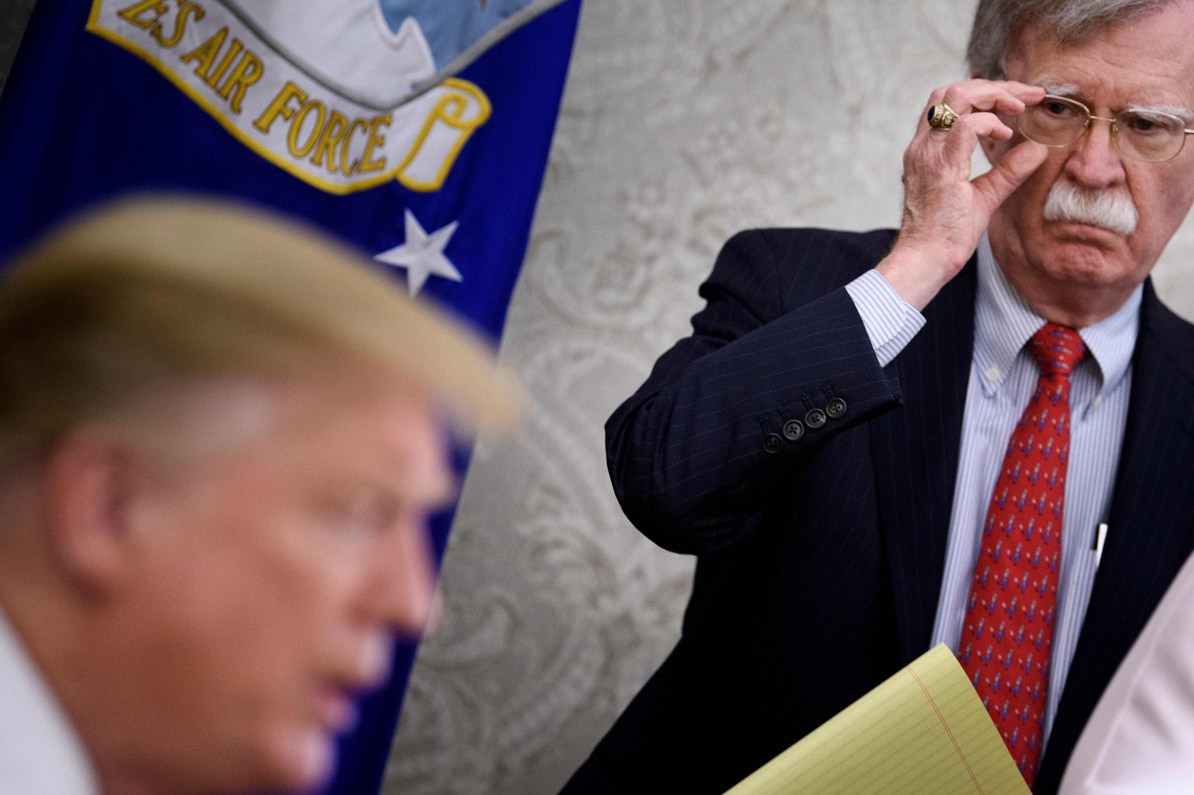 (FILES) In this file photo taken on May 13, 2019 National Security Advisor John Bolton listens while US President Donald Trump speaks to the press before a meeting with Hungary's Prime Minister Viktor Orban in the Oval Office of the White House in Washington, DC. - President Donald Trump on January 27, 2020 denied that he told his former national security advisor John Bolton that military aid to Ukraine was tied to Kiev investigating his political rivals. Trump's tweets came after The New York Times reported Sunday that Bolton alleges as much in a draft of his upcoming book.