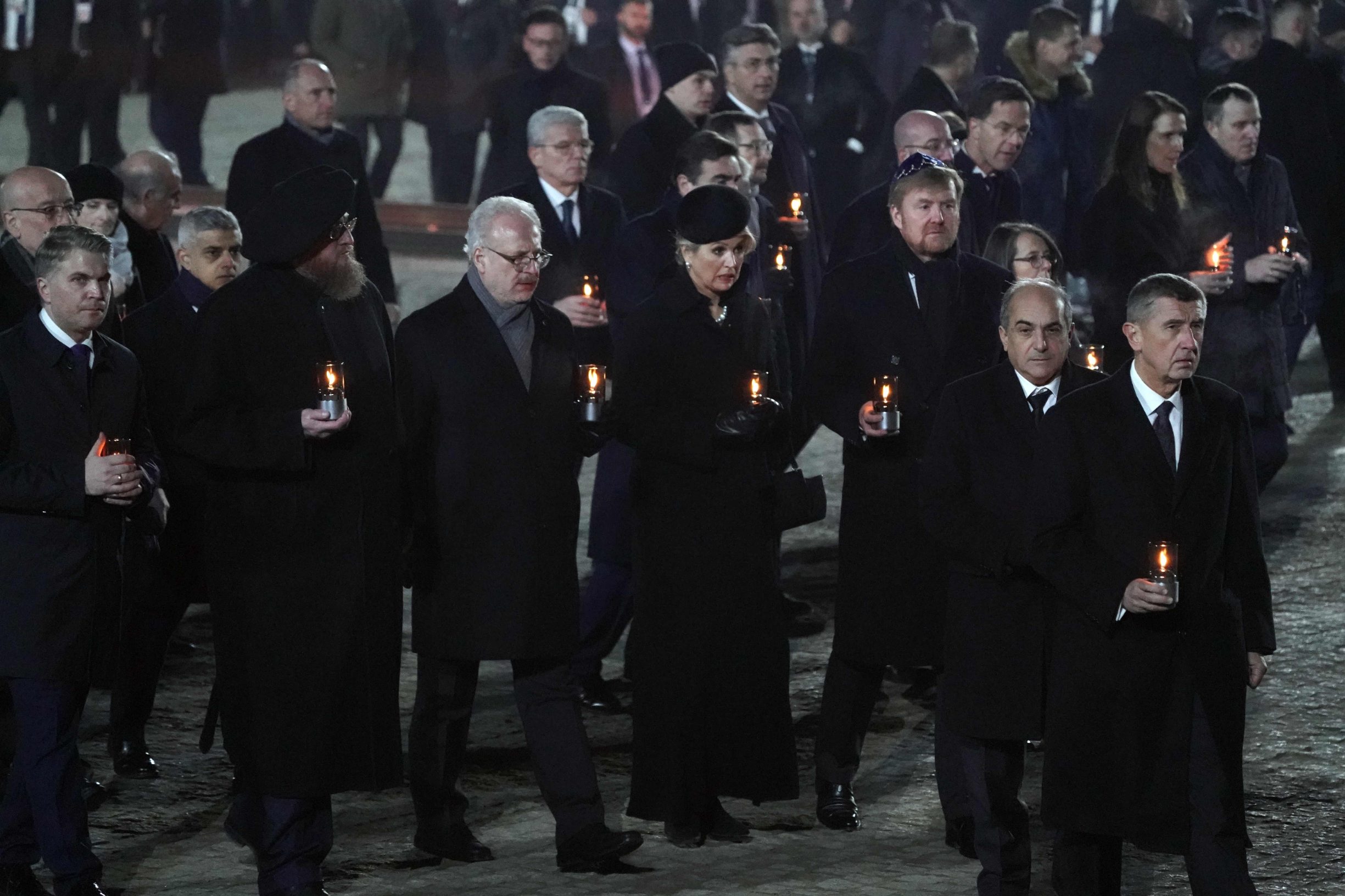 A deleagation of heads of state including Czech Prime Minister Andrej Babis (R) arrive for a candle lighting ceremony at the former German Nazi death camp Auschwitz-Birkenau during events to commemorate the 75th anniversary of the camp's liberation in Oswiecim, Poland, on January 27, 2020. - More than 200 survivors came from across the globe to the camp the Nazis built in Oswiecim in then-occupied Poland, to share their testimony as a stark warning amid a recent surge of anti-semitic attacks on both sides of the Atlantic. (Photo by Wojtek RADWANSKI / AFP)