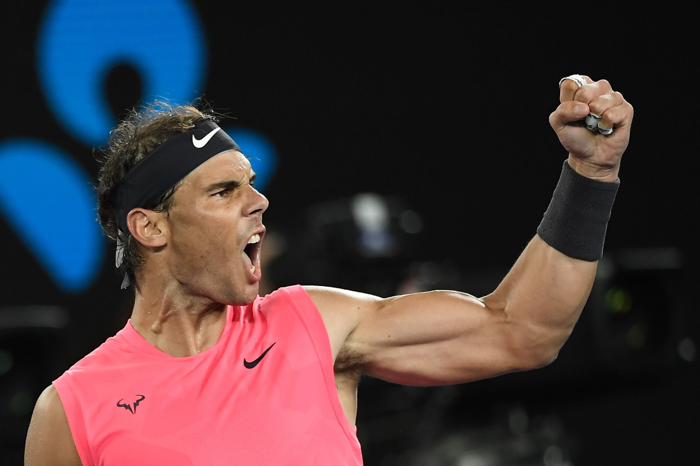 TOPSHOT - Spain's Rafael Nadal celebrates his victory against Australia's Nick Kyrgios during their men's singles match on day eight of the Australian Open tennis tournament in Melbourne on January 27, 2020. (Photo by Saeed KHAN / AFP) / IMAGE RESTRICTED TO EDITORIAL USE - STRICTLY NO COMMERCIAL USE