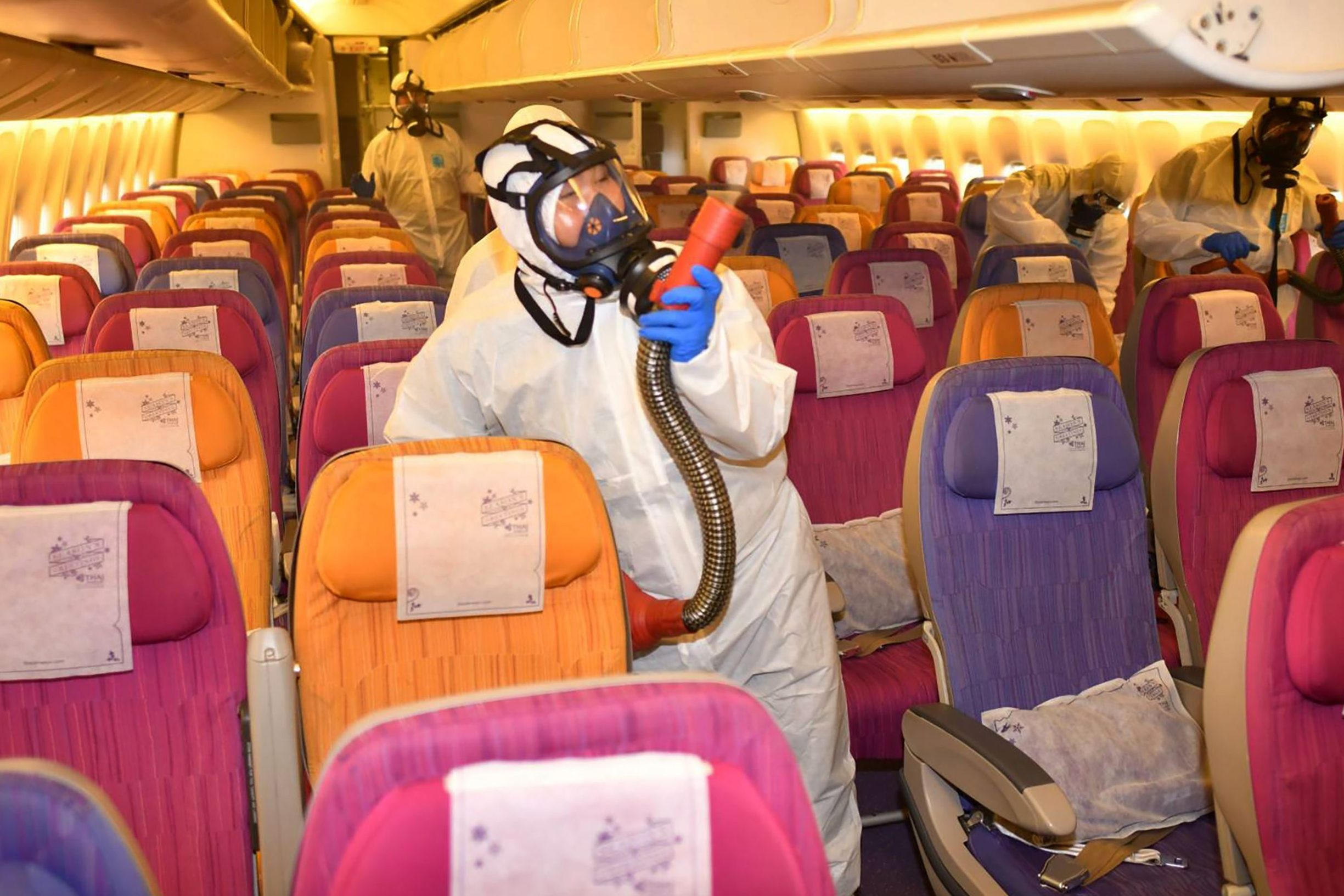 TOPSHOT - This handout from Thai Airways taken and released on January 28, 2020 shows staff disinfecting an aircraft at the airline's hangar in Bangkok, as a measure aimed at preventing the spread of novel coronavirus. - Thailand has detected 14 cases so far of the novel coronavirus, an outbreak which began in the Chinese city of Wuhan. (Photo by Handout / THAI AIRWAYS / AFP) / -----EDITORS NOTE --- RESTRICTED TO EDITORIAL USE - MANDATORY CREDIT 