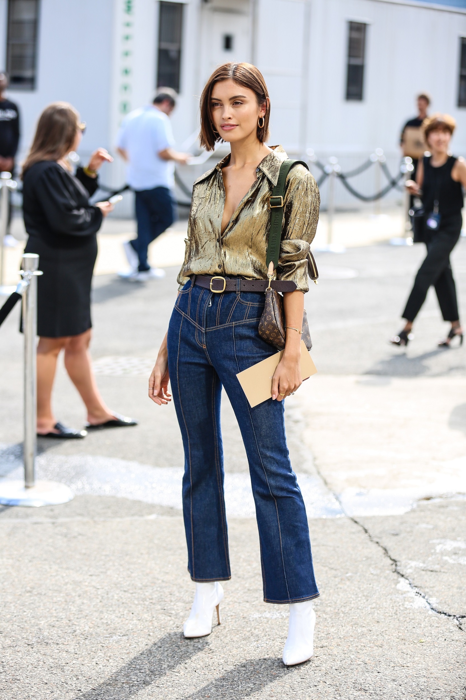 NEW YORK, NEW YORK - SEPTEMBER 11: A guest is seen wearing a gold tops and blue jeans during New York Fashion Week on September 11, 2019 in New York City. (Photo by Donell Woodson/Getty Images)