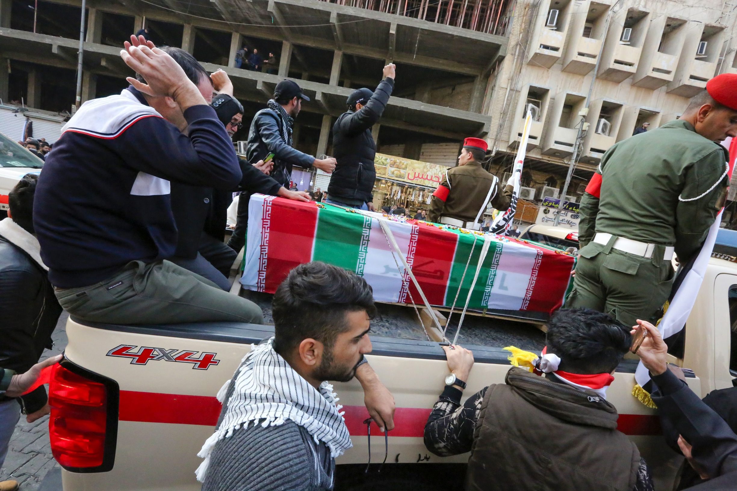 Iraqis mourn over a coffin during the funeral procession of Iraqi paramilitary chief Abu Mahdi al-Muhandis and Iranian military commander Qasem Soleimani, and eight others, in Kadhimiya, a Shiite pilgrimage district of Baghdad, on January 4, 2020. - Thousands of Iraqis chanting 