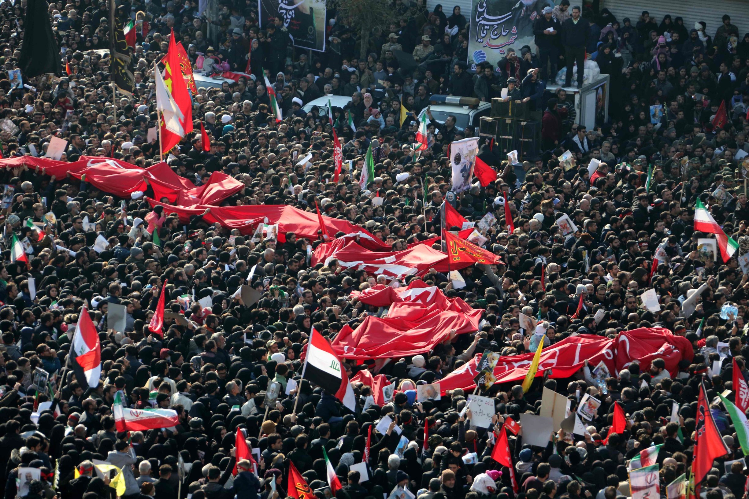 Iranian mourners take part in a funeral procession in the capital Tehran on January 6, 2020, for slain military commander Qasem Soleimani, Iraqi paramilitary chief Abu Mahdi al-Muhandis, and other victims of a US attack. - Downtown Tehran was brought to a standstill as mourners flooded the Iranian capital to pay an emotional homage to Soleimani, the 