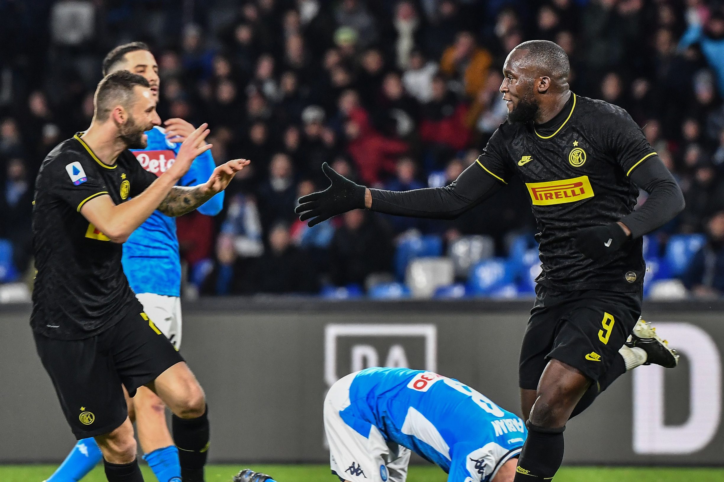 Inter Milan's Belgian forward Romelu Lukaku (R) celebrates with Inter Milan's Croatian defender Marcelo Brozovic after scoring his second goal during the Italian Serie A football match Napoli vs Inter Milan on January 6, 2020 at the San Paolo stadium in Naples. (Photo by Tiziana FABI / AFP)
