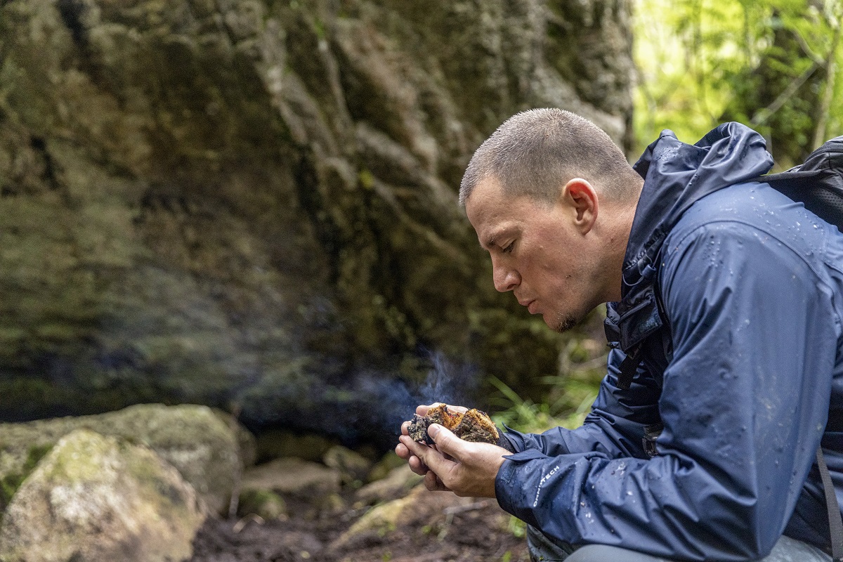 Norway - Channing Tatum gently blows on a Chaga mushroom to keep an ember glowing for National Geographic's RUNNING WILD WITH BEAR GRYLLS. (National Geographic/Ben Simms)