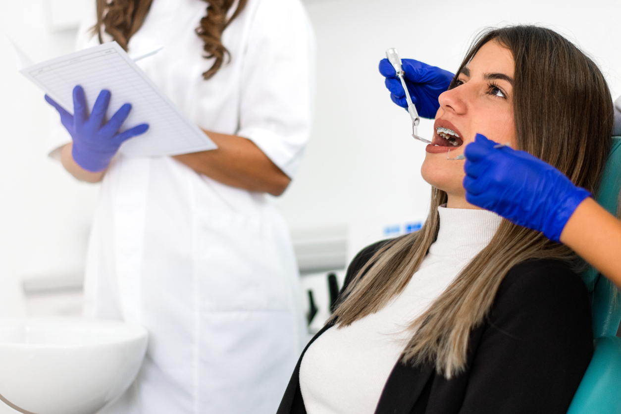 Young woman having teeth examined at dentists