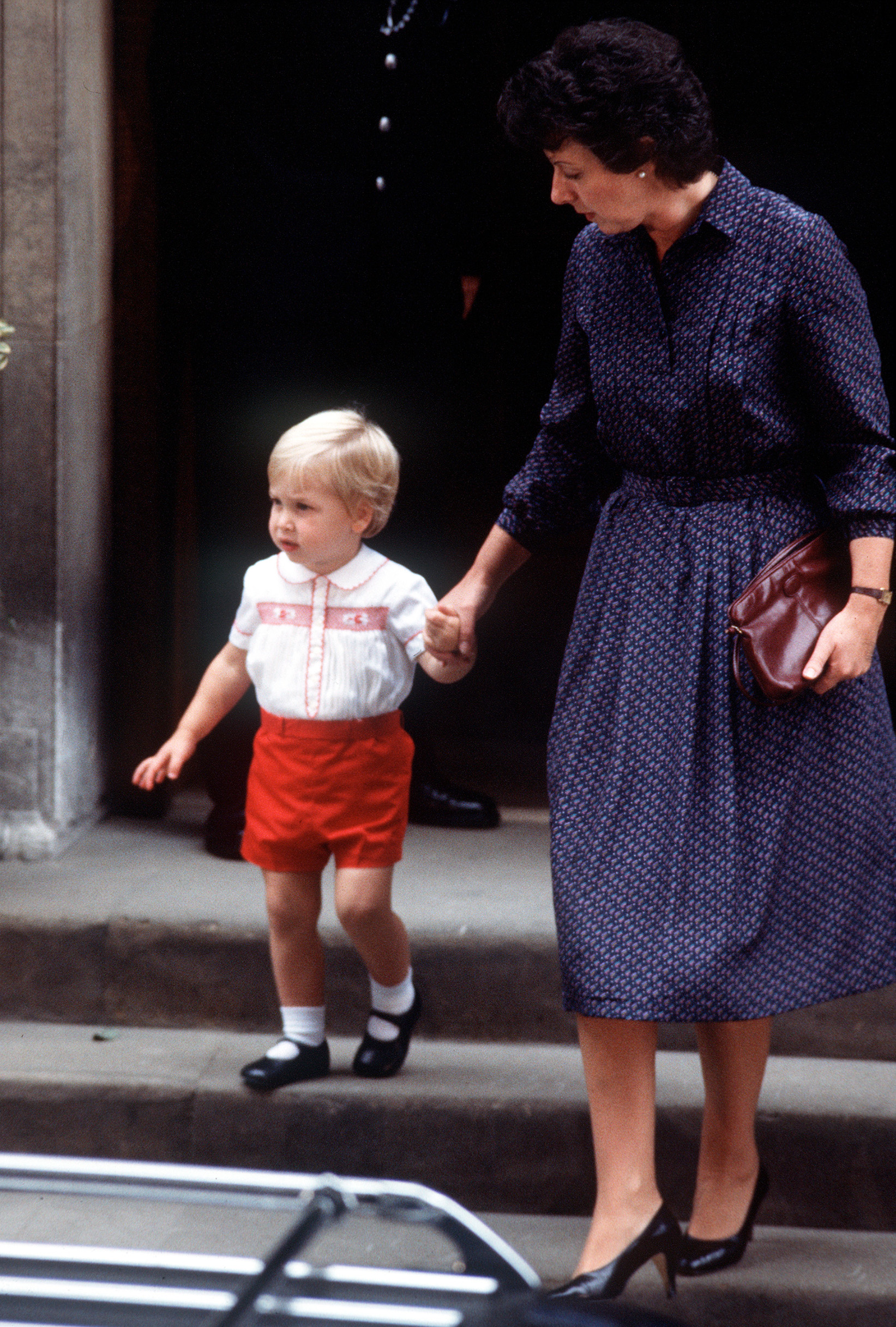A young Prince William, accompanied by nanny Barbara Barnes, leaves St Mary's hospital, London on September 16, 1984 after seeing his newly born baby brother, Prince Harry. Prince George is seen wearing the same clothes as he attends the christening of his baby sister Princess Charlotte on July 5, 2015,Image: 251945155, License: Rights-managed, Restrictions: None, Model Release: no, Credit line: Anwar Hussein / PA Images / Profimedia