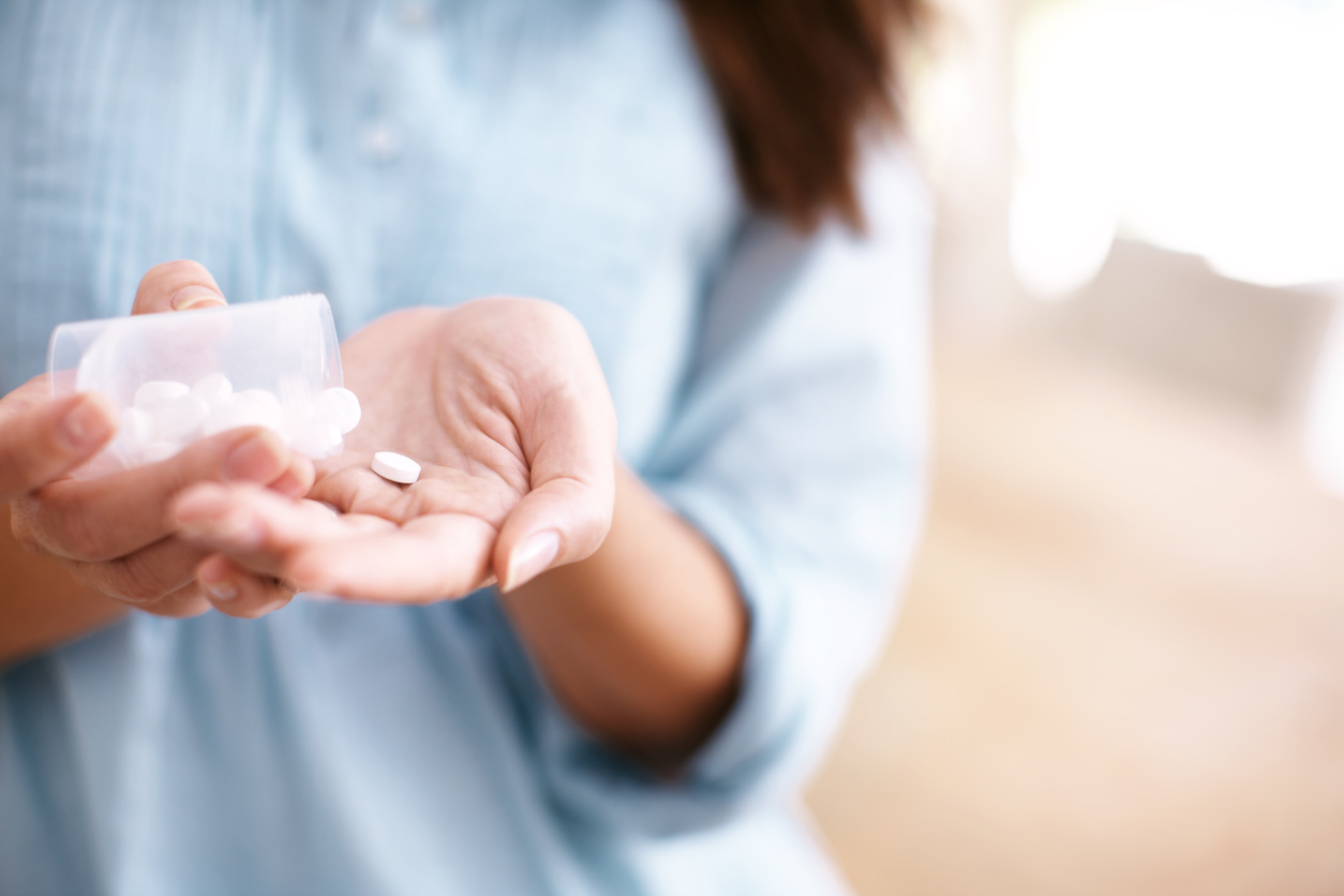 A mature woman taking medication