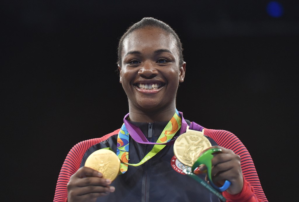 Gold medalist USA's Claressa Maria Shields reacts during the medal presentation ceremony following the Women's Middle (69-75kg) Final Bout at the Rio 2016 Olympic Games at the Riocentro - Pavilion 6 in Rio de Janeiro on August 21, 2016. (Photo by YURI CORTEZ / AFP)