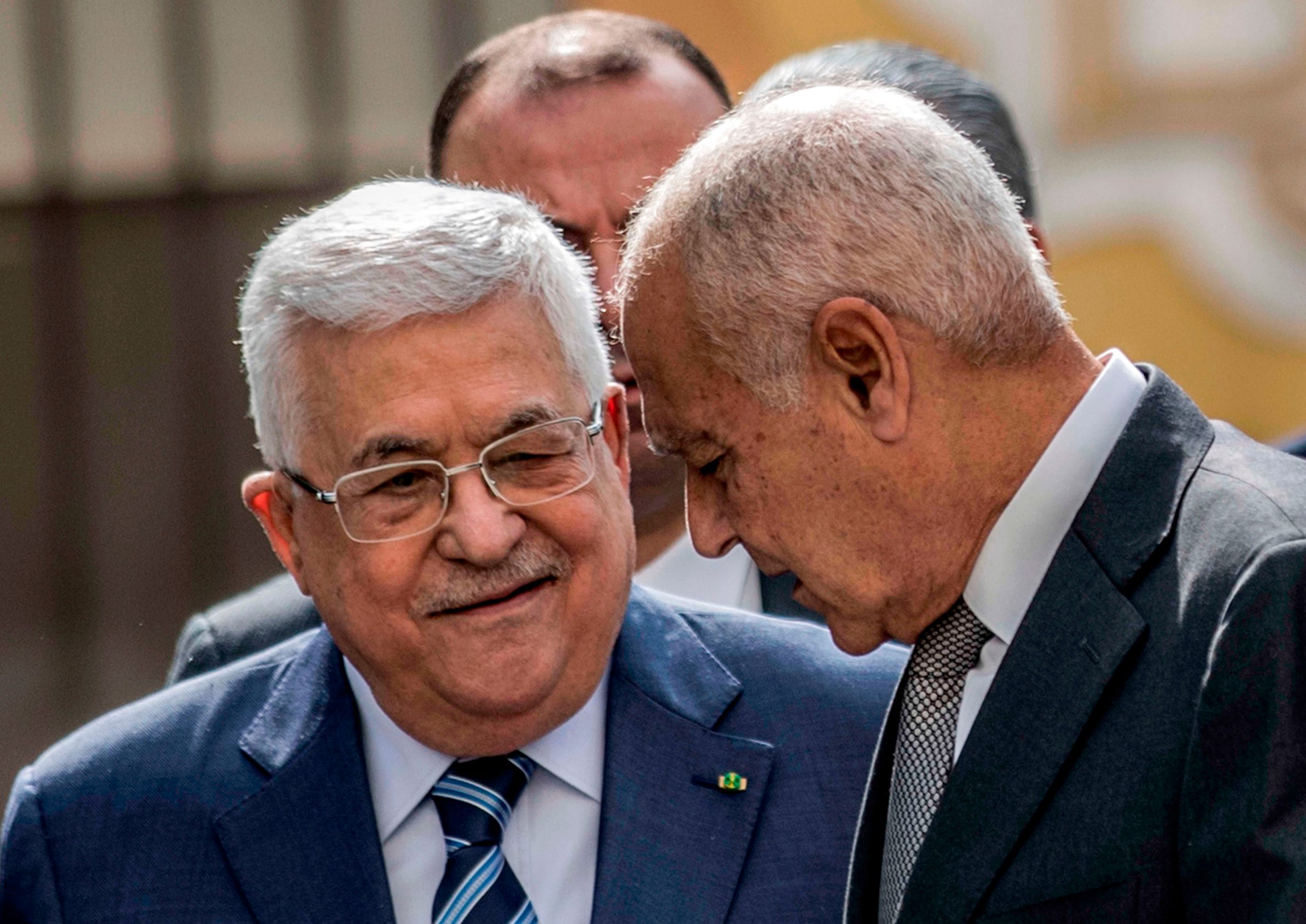 Palestinian president Mahmud Abbas (L) speaks with Arab League Secretary-General Ahmed Aboul Gheit as they arrive to attend an Arab League emergency meeting discussing the US-brokered proposal for a settlement of the Middle East conflict at the league headquarters in the Egyptian capital Cairo on February 1, 2020. (Photo by Khaled DESOUKI / AFP)
