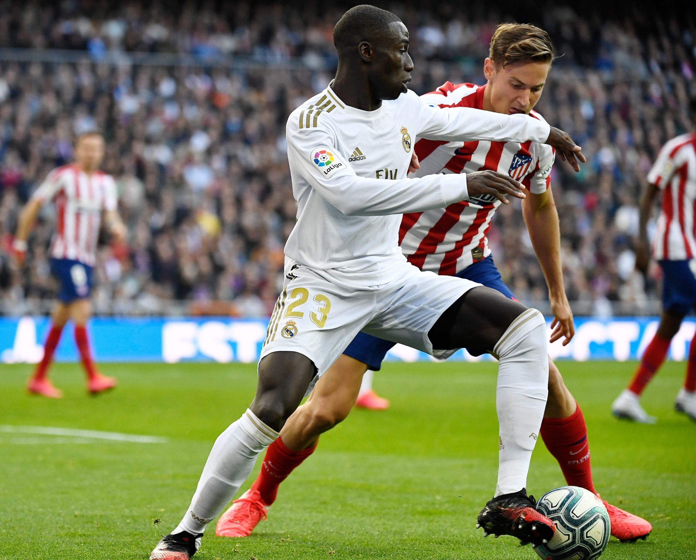 Real Madrid's French defender Ferland Mendy (L) vies with Atletico Madrid's Spanish midfielder Marcos Llorente during the Spanish league football match between Real Madrid CF and Club Atletico de Madrid at the Santiago Bernabeu stadium in Madrid on February 1, 2020. (Photo by PIERRE-PHILIPPE MARCOU / AFP)