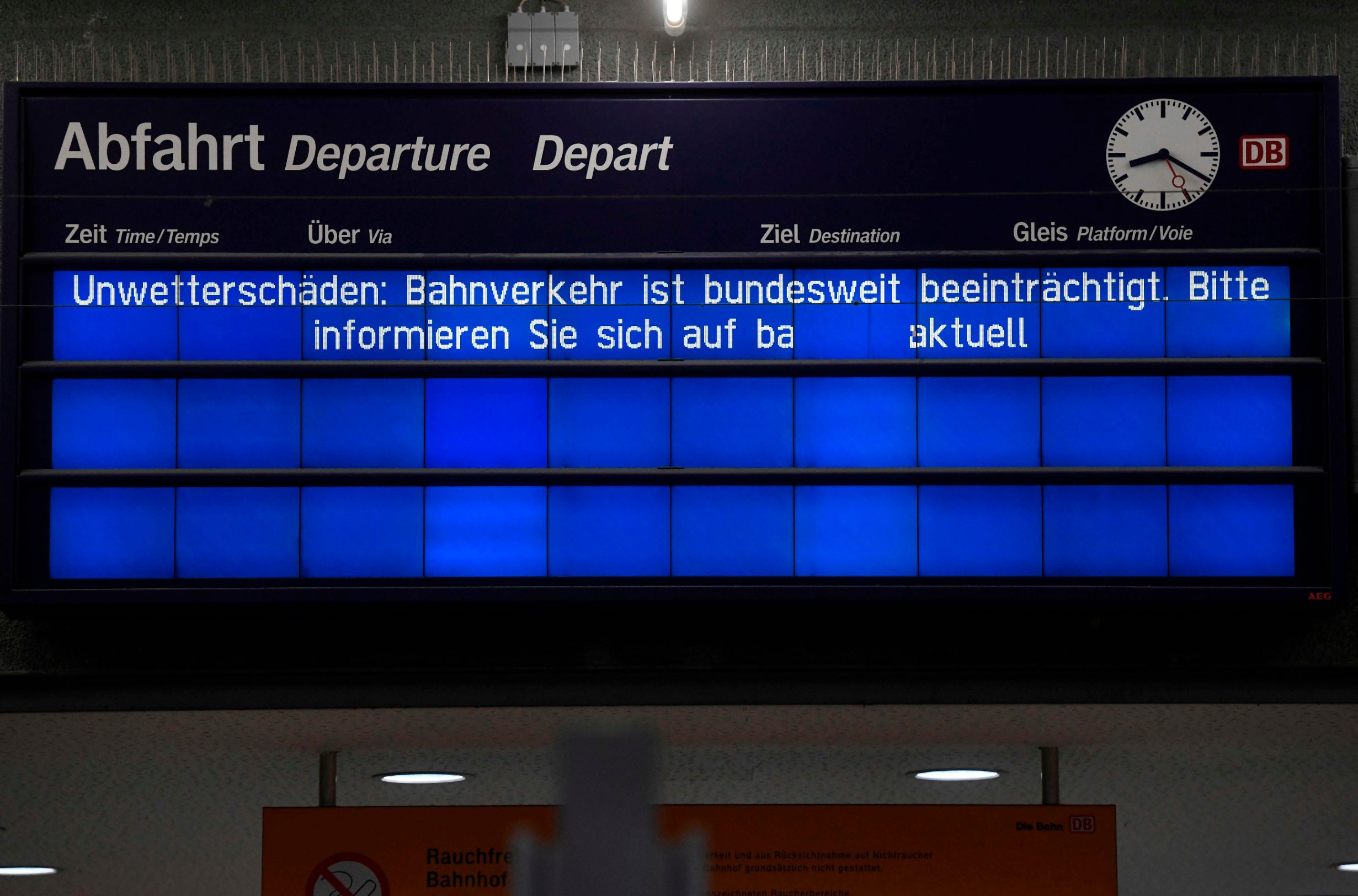 A screen displays informations reading 'Storm damage' at the central railway station in Bochum, western Germany on February 10, 2020. - Germany asessed damage on Monday as a powerful storm disrupted air, rail and sea links, canceled sports events, cut electrical power and damaged property in western Germany on Sunday. With howling winds and driving rain, forecasters said Ciara would pummel southern Germany Monday with school closures in parts of Bavaria and Badem-Wurtemberg. (Photo by Ina FASSBENDER / AFP)