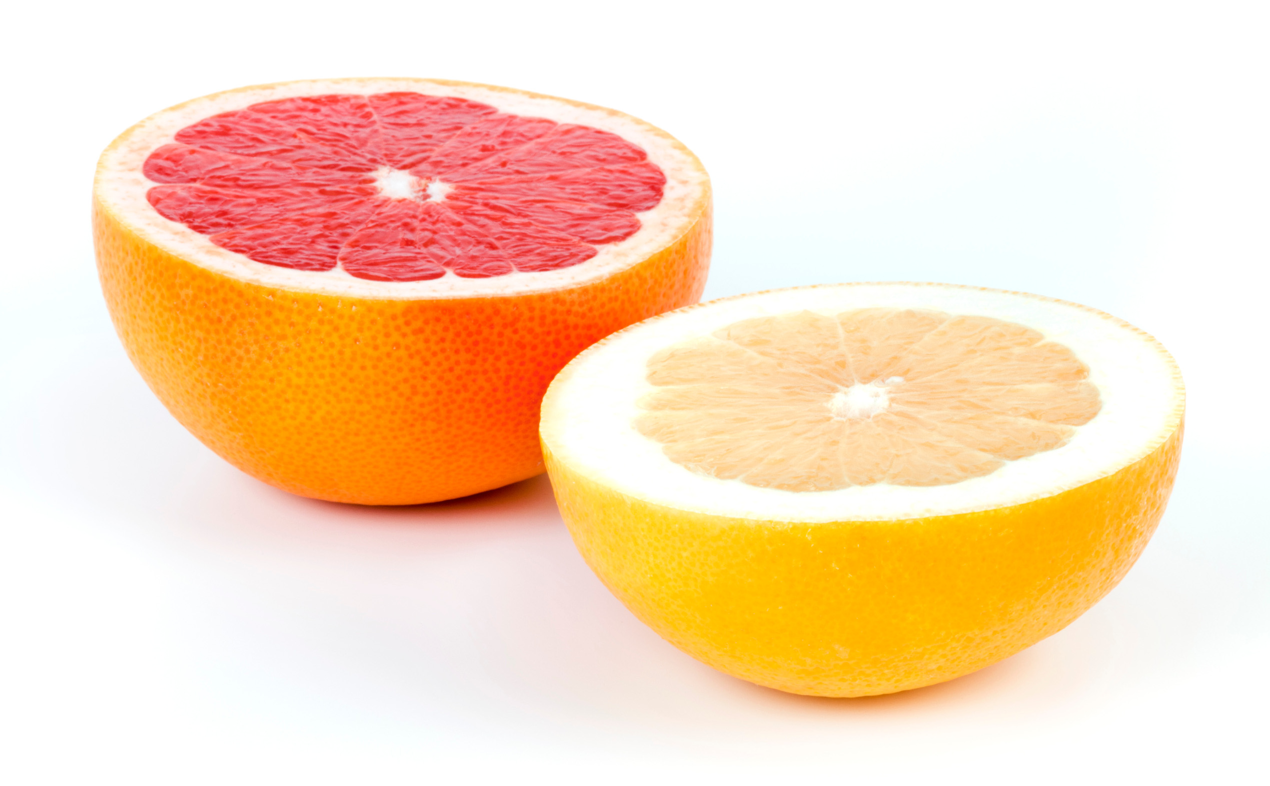 Halves of white and red Grapefruits isolated on white background.