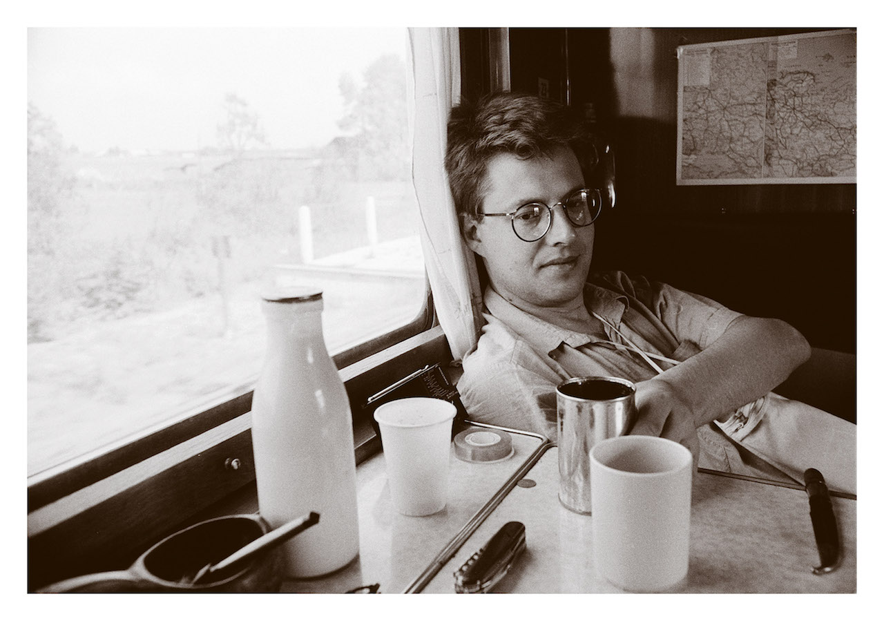 Stieg Larsson on assaignment 1987 for swedish newsagency TT and travel magazine Vagabond on the Trans Siberian Railroad heading for Beijing and Hong Kong. On the wall behind a maap over Russia, some russiian milk and a cup of chai. Stieg Larsson loved the traveling life and was a wayfairing man.