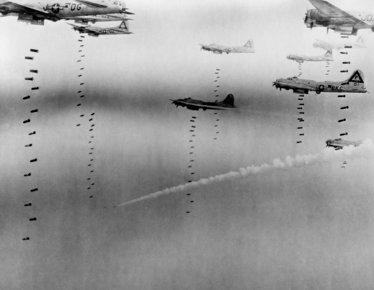 B-17 Flying Fortresses of U.S. 8th Air Force bombing Dresden in April 17, 1945. A disabled plane leaves a smoke trail as it descends in the background. The raid targeted three railway choke points to close the German Escape Route southeast to the Mountains. April 17, 1945, World War 2. (BSLOC_2014_6_14), Image: 194866772, License: Rights-managed, Restrictions: For usage credit please use;, Model Release: no, Credit line: - / Everett / Profimedia