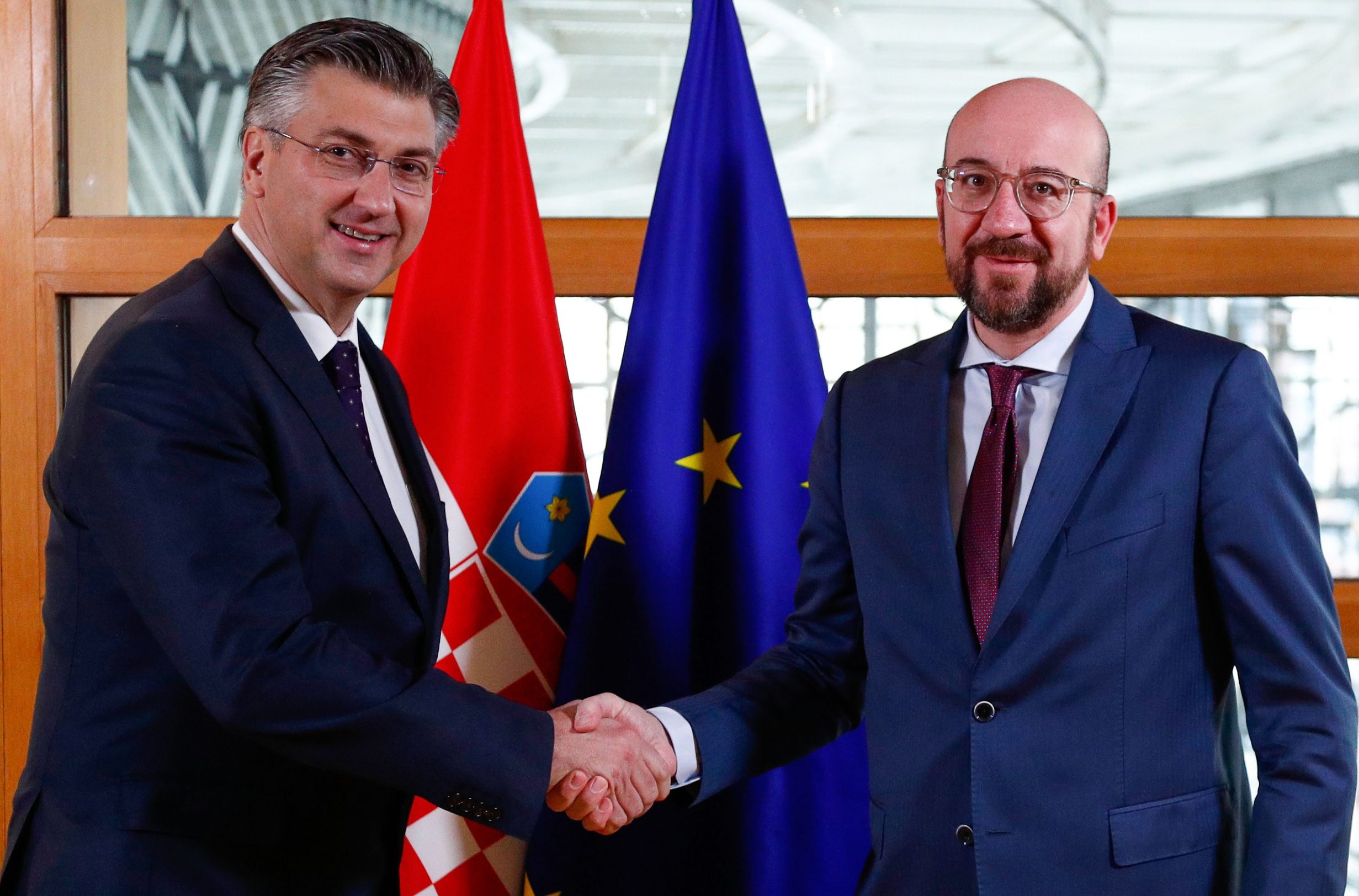President of the European Council Charles Michel (R) welcomes Croatia's Prime Minister Andrej Plenkovic