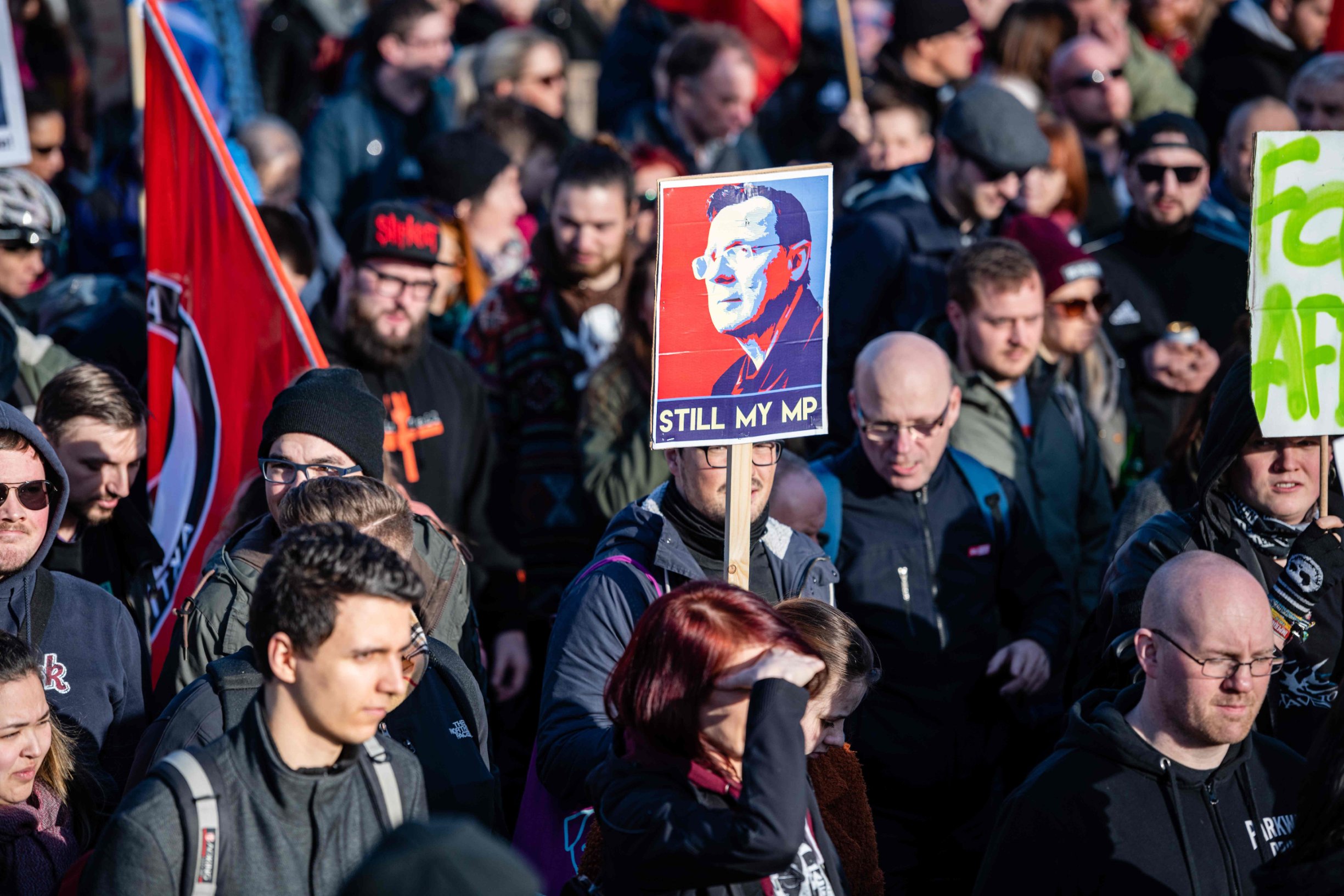 Demonstrators hold a poster showing former Thuringian state premier Bodo Ramelow and reading 