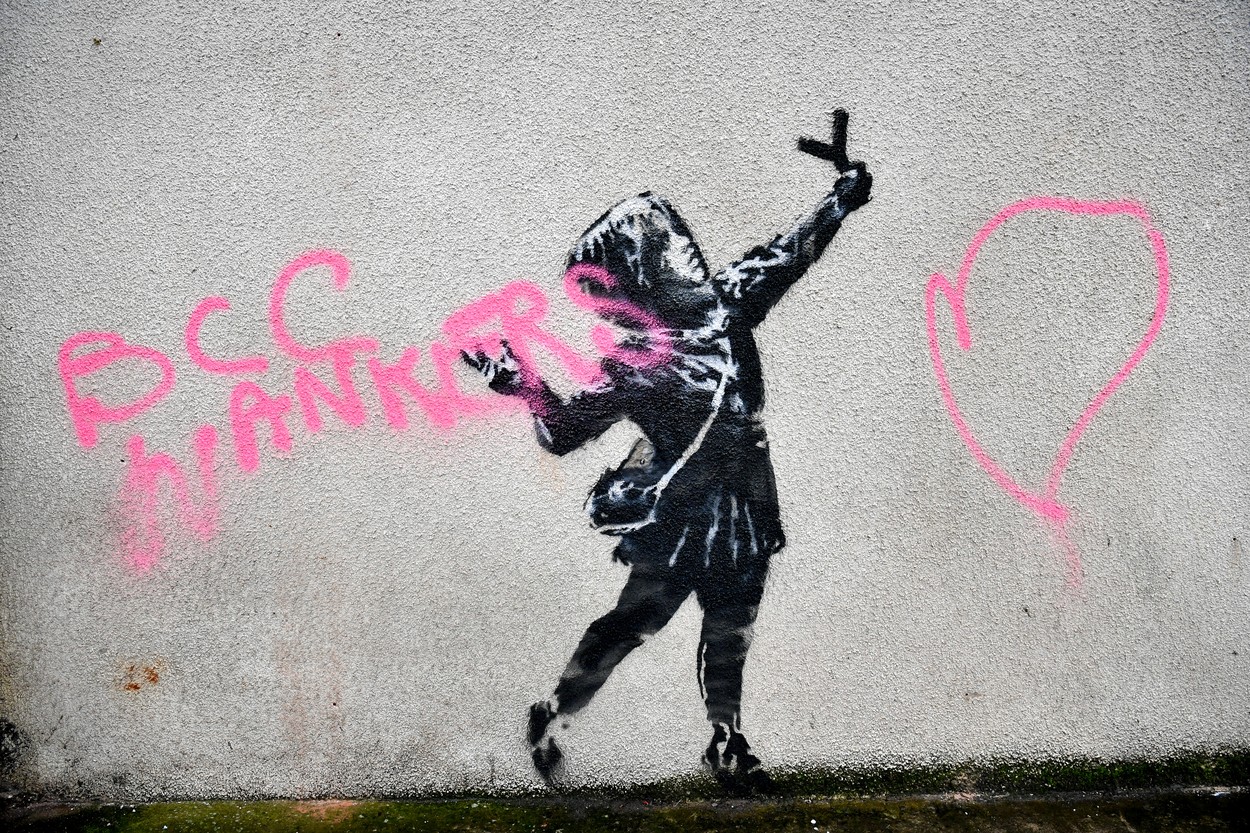NOTE IMAGE CONTAINS SWEAR WORD A Banksy work of art on the side of a house on Marsh Lane, Barton Hill, Bristol, which has been vandalised with pink spray paint, the day after it was confirmed on Valentine's Day., Image: 498737846, License: Rights-managed, Restrictions: , Model Release: no, Credit line: Ben Birchall / PA Images / Profimedia