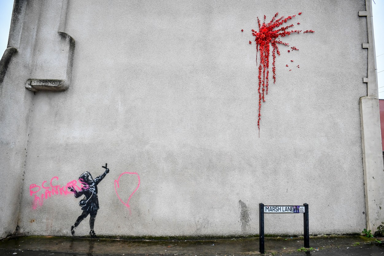 NOTE IMAGE CONTAINS SWEAR WORD A Banksy work of art on the side of a house on Marsh Lane, Barton Hill, Bristol, which has been vandalised with pink spray paint, the day after it was confirmed on Valentine's Day., Image: 498737847, License: Rights-managed, Restrictions: , Model Release: no, Credit line: Ben Birchall / PA Images / Profimedia