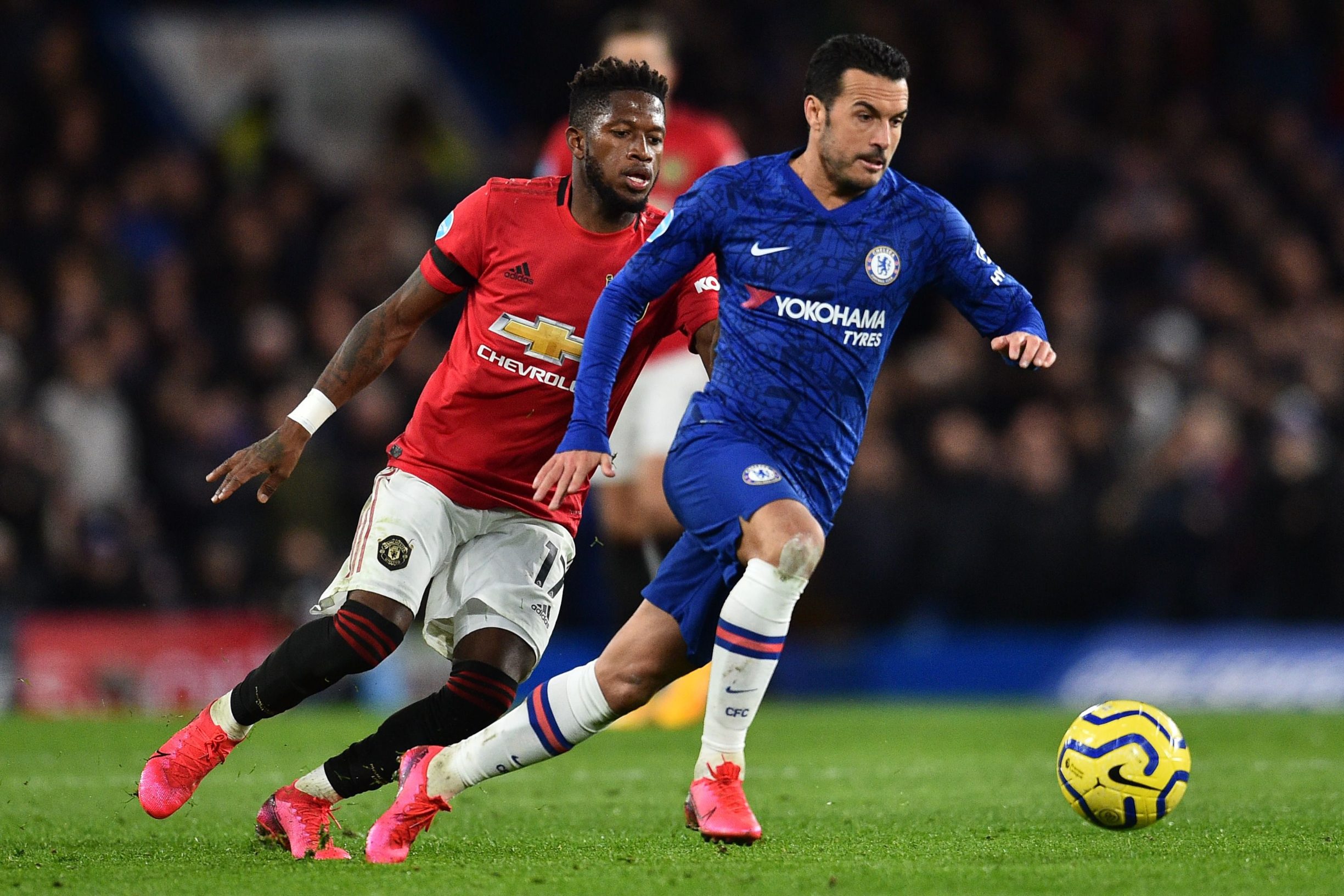 Chelsea's Spanish midfielder Pedro (R) runs away from Manchester United's Brazilian midfielder Fred during the English Premier League football match between Chelsea and Manchester United at Stamford Bridge in London on February 17, 2020. (Photo by Glyn KIRK / AFP) / RESTRICTED TO EDITORIAL USE. No use with unauthorized audio, video, data, fixture lists, club/league logos or 'live' services. Online in-match use limited to 120 images. An additional 40 images may be used in extra time. No video emulation. Social media in-match use limited to 120 images. An additional 40 images may be used in extra time. No use in betting publications, games or single club/league/player publications. / 