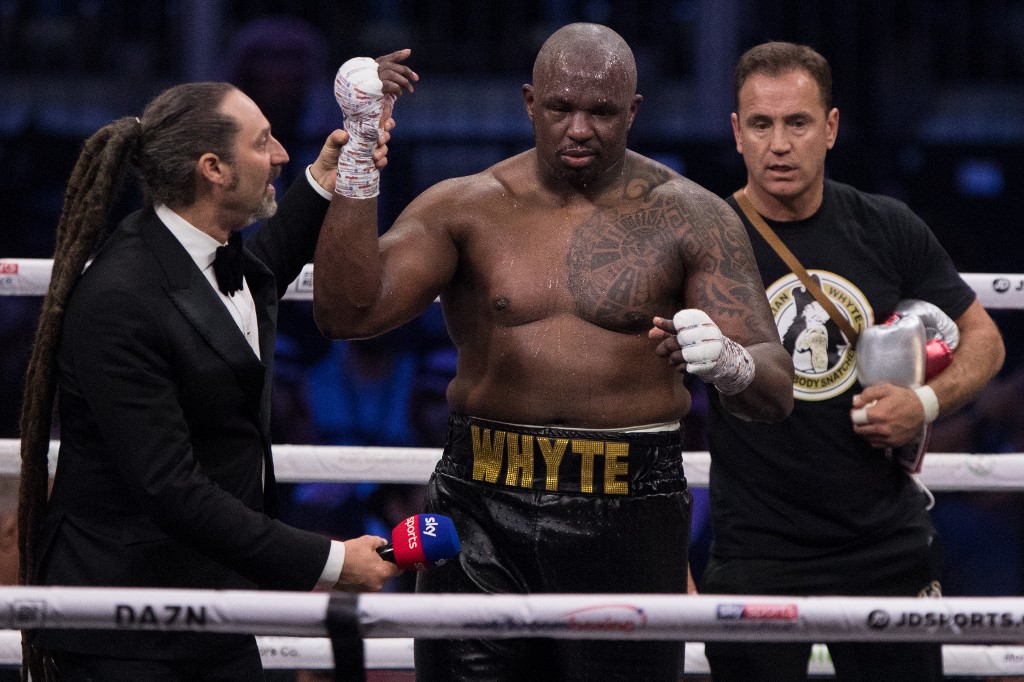 dpatop - 07 December 2019, Saudi Arabia, Diriyah: British professional boxer Dillian Whyte celebrates defeating Polish Mariusz Wach (not pictured) in their Heavyweight contest at the Diriyah Arena. Photo: Oliver Weiken/dpa