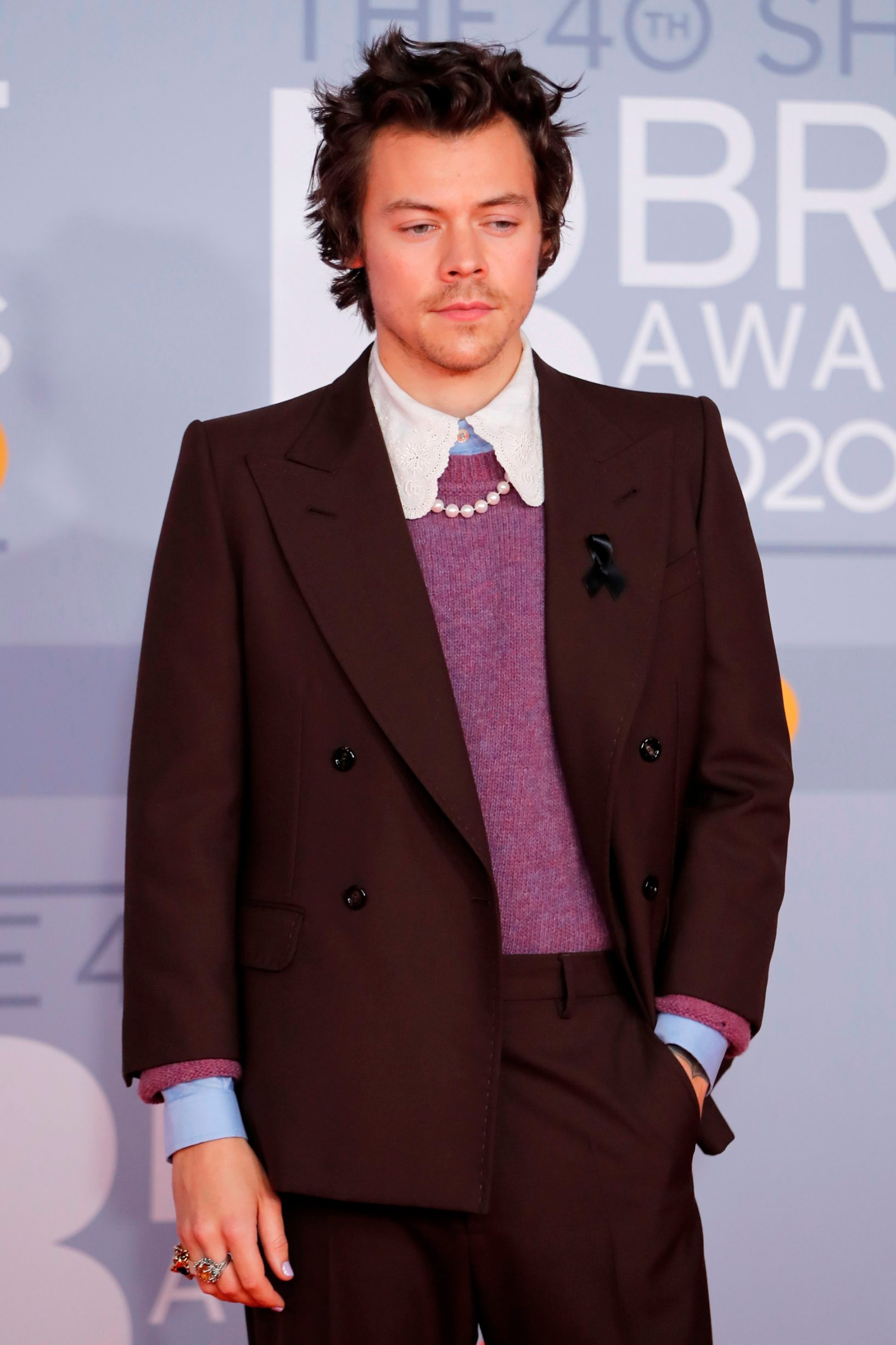 British singer-songwriter Harry Styles poses on the red carpet on arrival for the BRIT Awards 2020 in London on February 18, 2020. (Photo by Tolga AKMEN / AFP) / RESTRICTED TO EDITORIAL USE  NO POSTERS  NO MERCHANDISE NO USE IN PUBLICATIONS DEVOTED TO ARTISTS