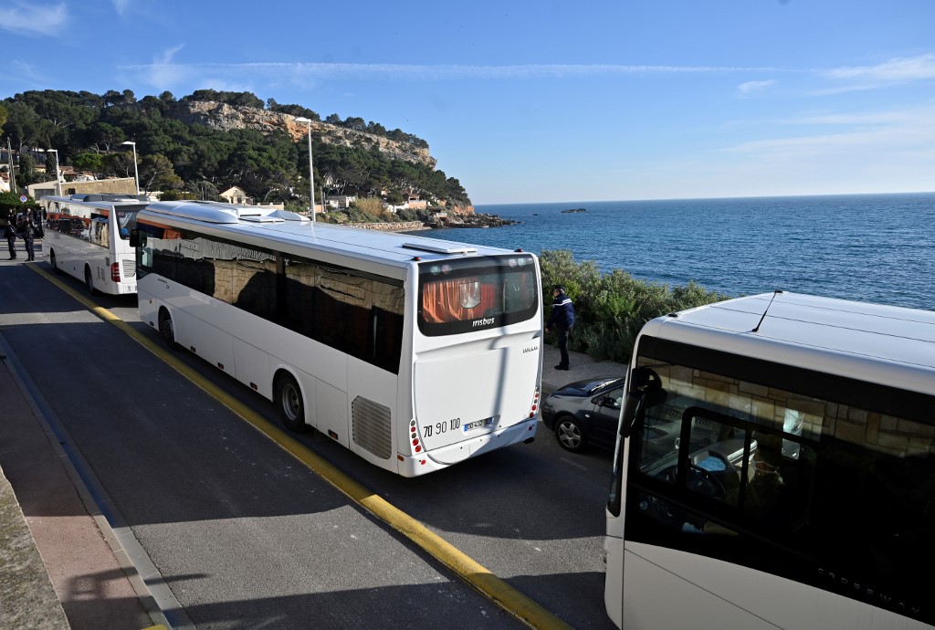 Vehicles believed to contain French citizens after their evacuation from the Chinese city of Wuhan, arrive at The Vacanciel Holiday Resort in Carry-le-Rouet, near Marseille, southern France on January 31, 2020, following their repatriation from the coronavirus zone. - A plane carrying around 200 French citizens evacuated from the Chinese city of Wuhan, epicentre of the coronavirus outbreak, landed near Marseille, AFP reporters onboard the aircraft said. The passengers, who will be placed in quarantine at a seaside holiday camp for two weeks, applauded as the plane touched down at the Istres military base. None have shown any symptoms of the virus that has killed 213 people and infected nearly 10,000 in mainland China, prompting the World Health Organization to declare a global emergency. (Photo by GERARD JULIEN / AFP)