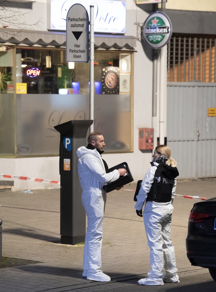 20 February 2020, Hessen, Hanau: Forensics officers are on duty near a crime scene at Heumarkt. Several people have been killed by gunshots in Hanau, Hesse. Photo: Boris Roessler/dpa
